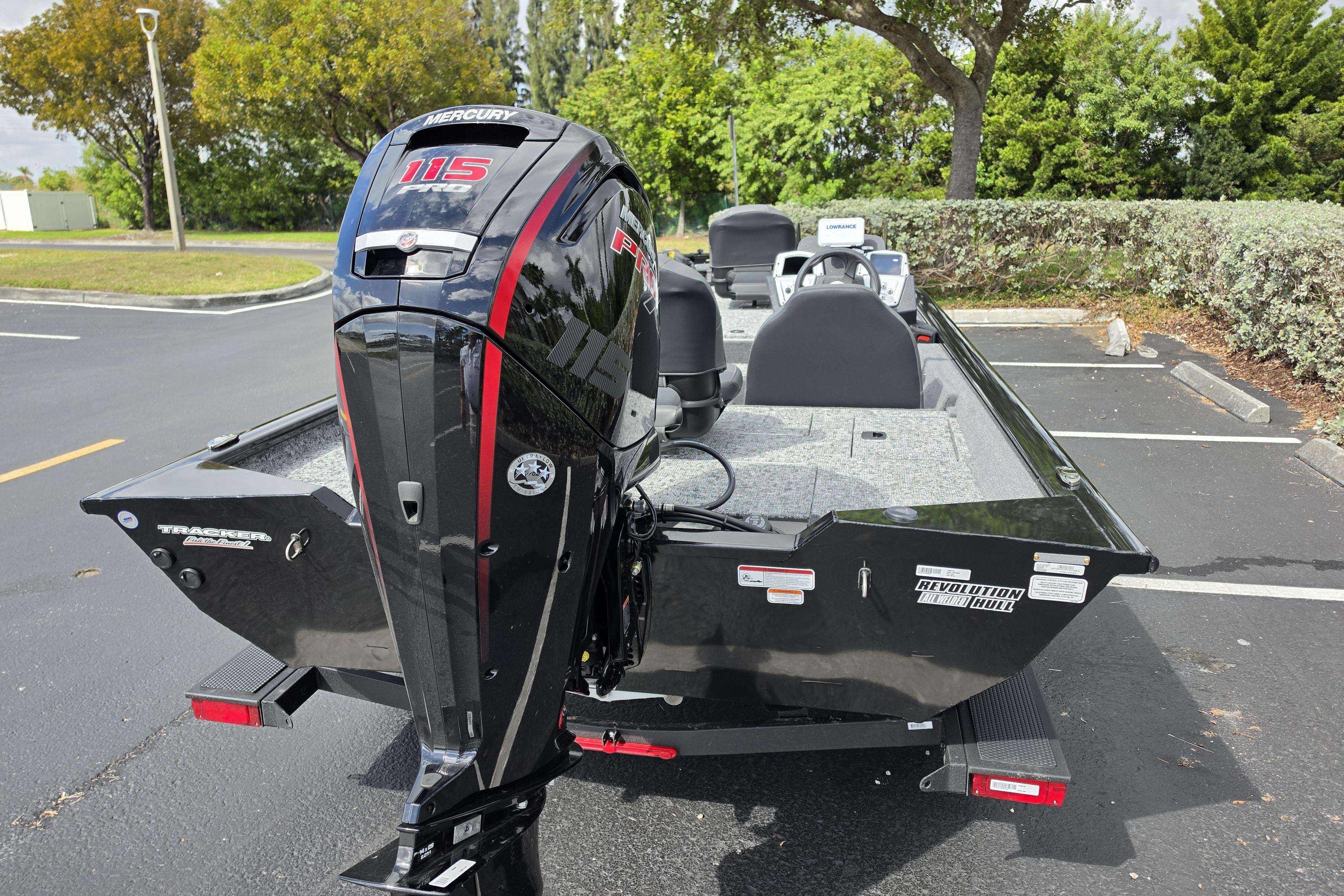 2026 Tracker Pro Team 190 boat with Mercury 115 engine in parking lot.