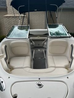 The image shows the cockpit of a Chaparral 190 SSi boat with white seats and a blue canopy.