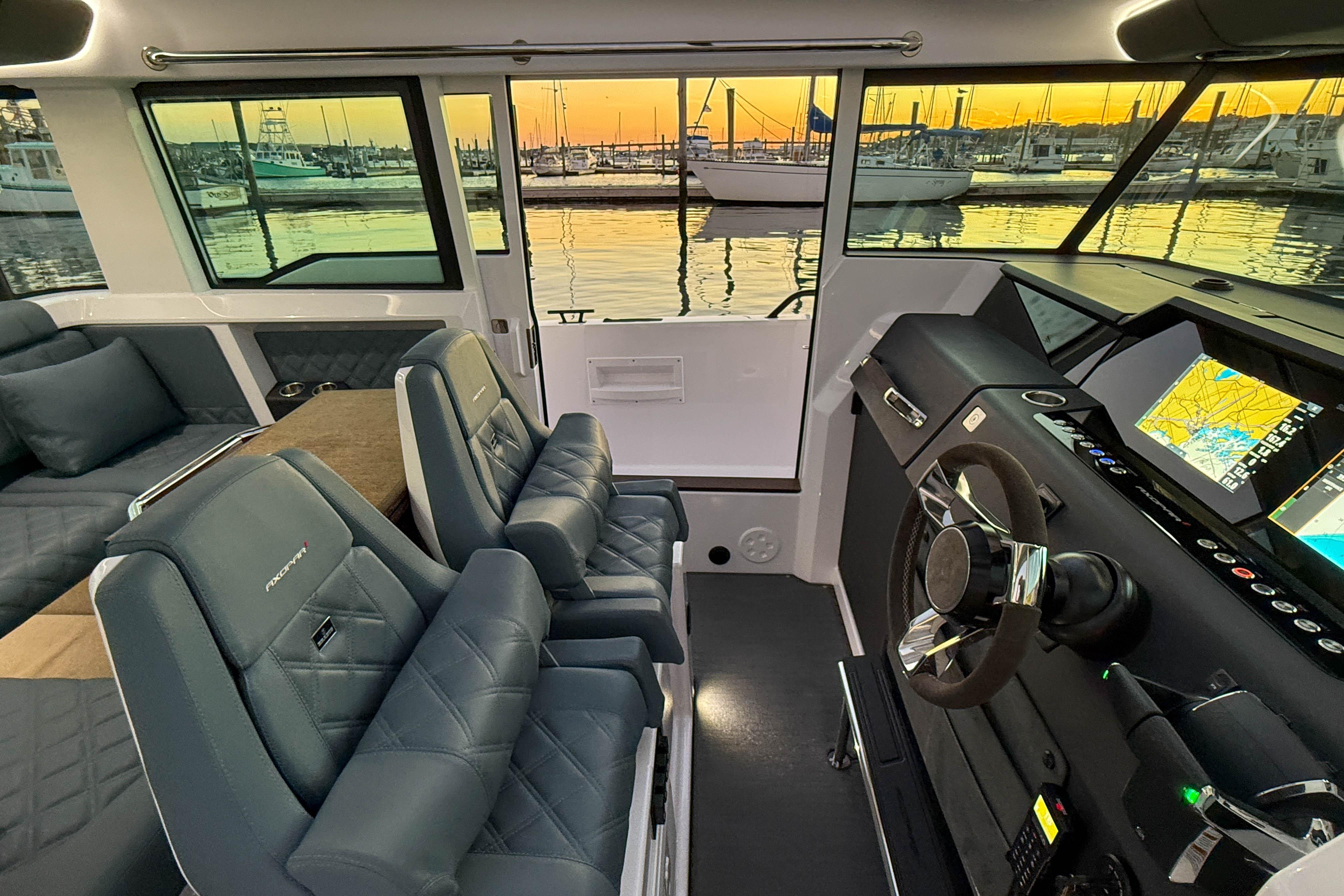 Interior of 2022 Axopar 37 XC CROSS CABIN with luxurious seating and modern navigation system.