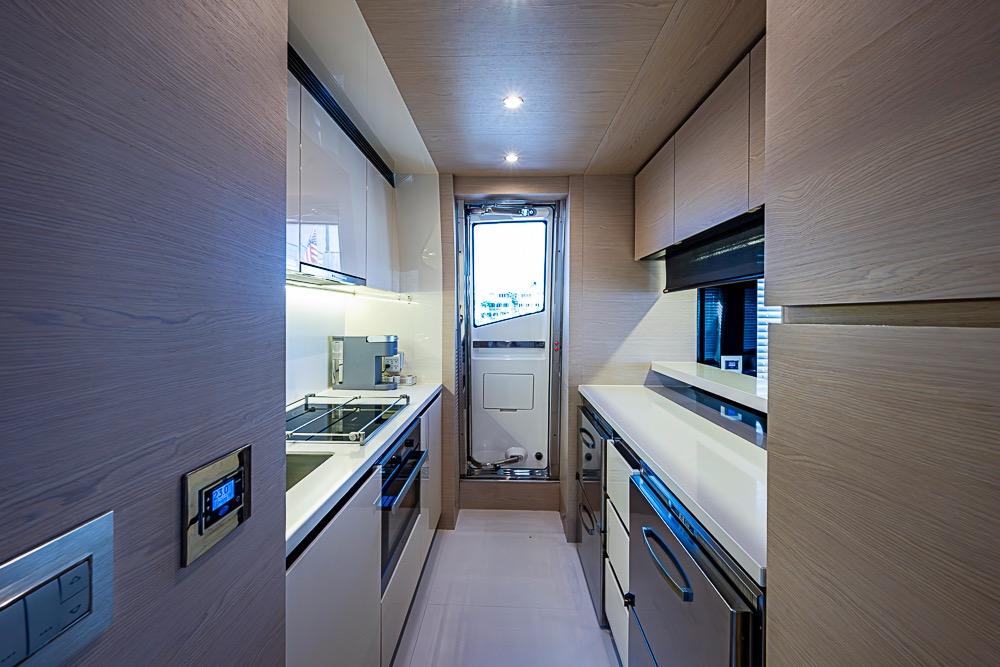 Modern kitchen interior on 2017 Azimut 80 yacht, featuring sleek cabinetry and appliances.