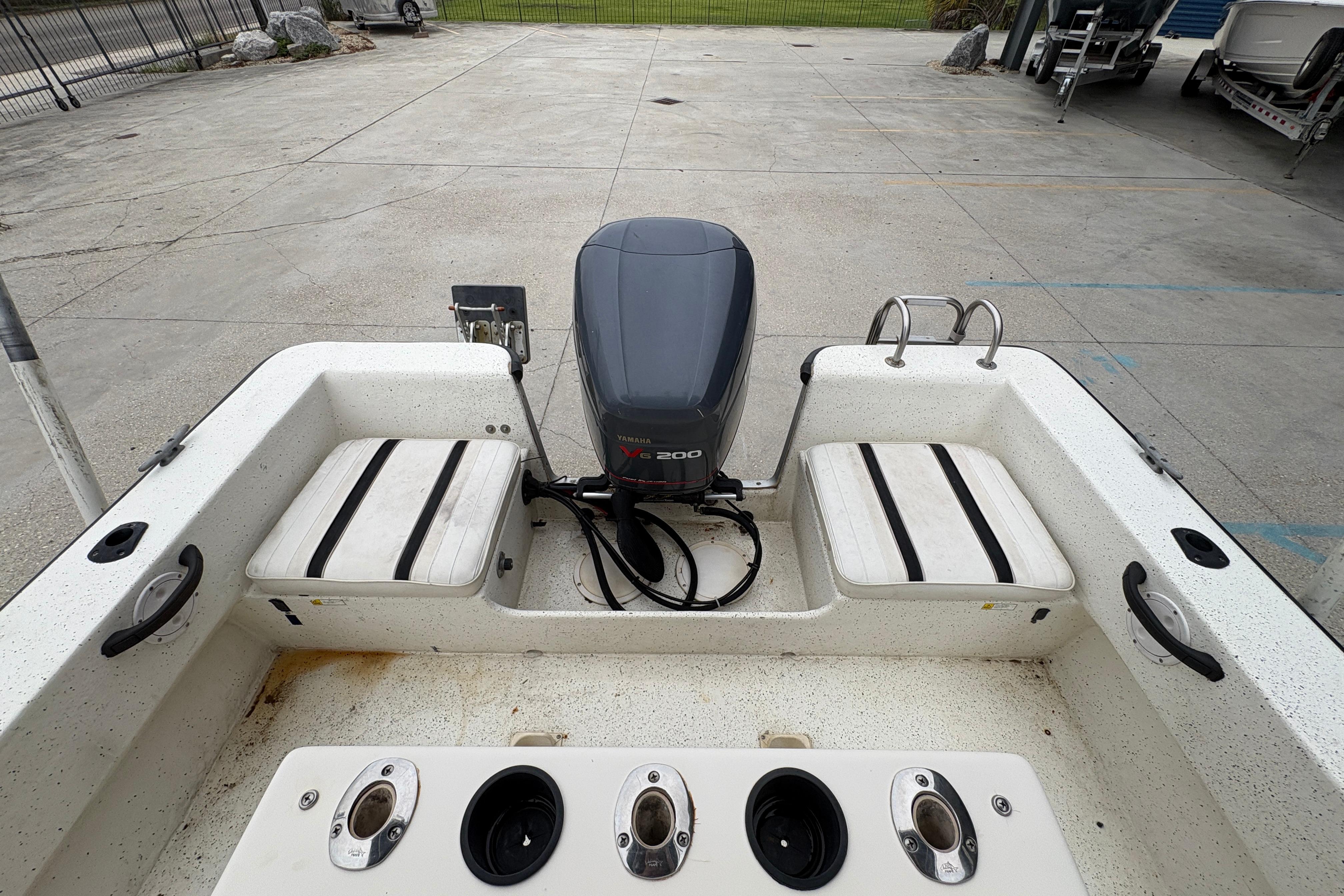 1998 Hydra-Sports 22 Ocean CC boat with Yamaha V6 200 engine, docked on concrete.