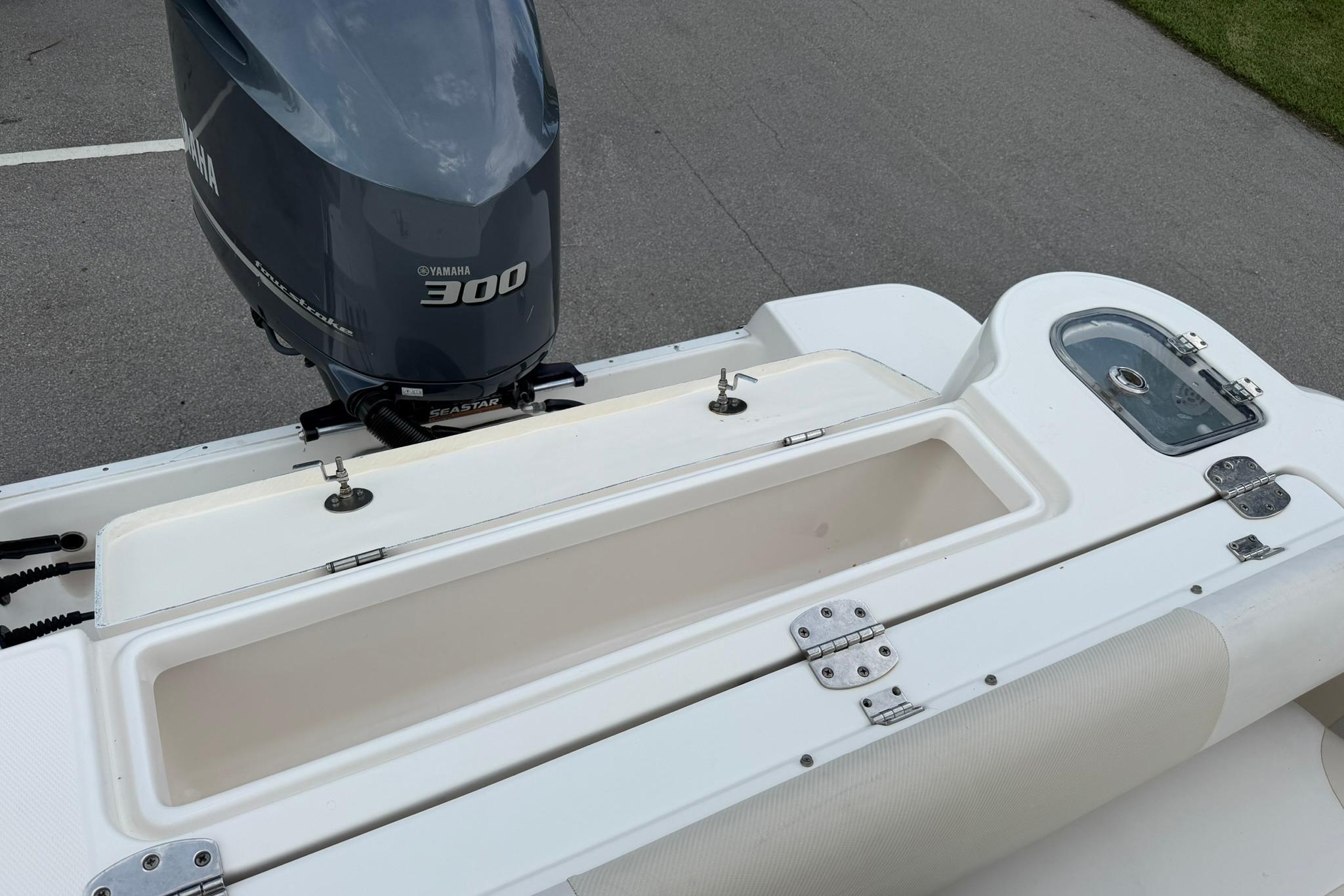 2019 Robalo R247 Dual Console boat with Yamaha 300 engine, featuring storage compartments.