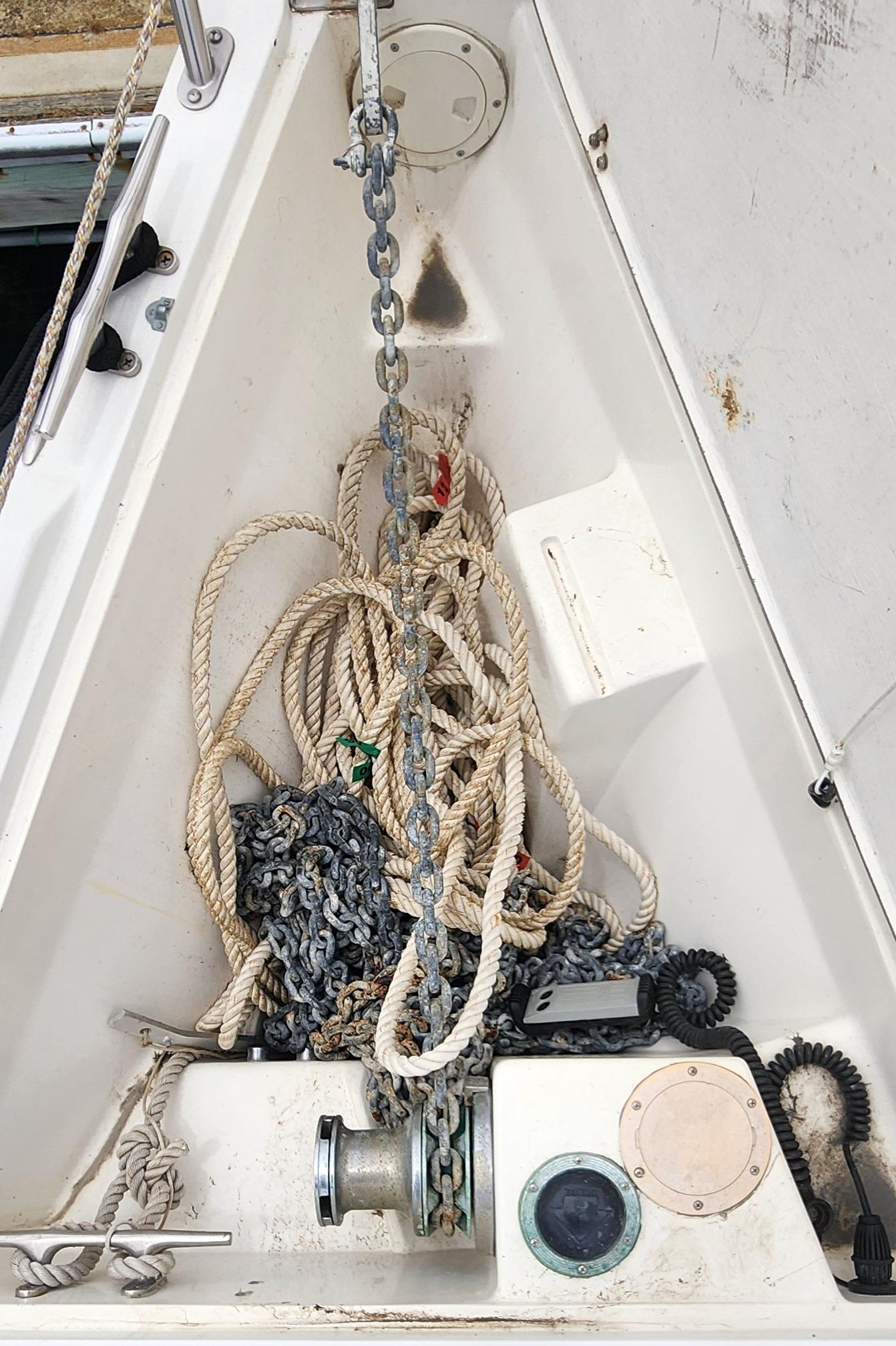 Anchor locker of a 1995 Catalina 42 MkII sailboat with ropes and chains.