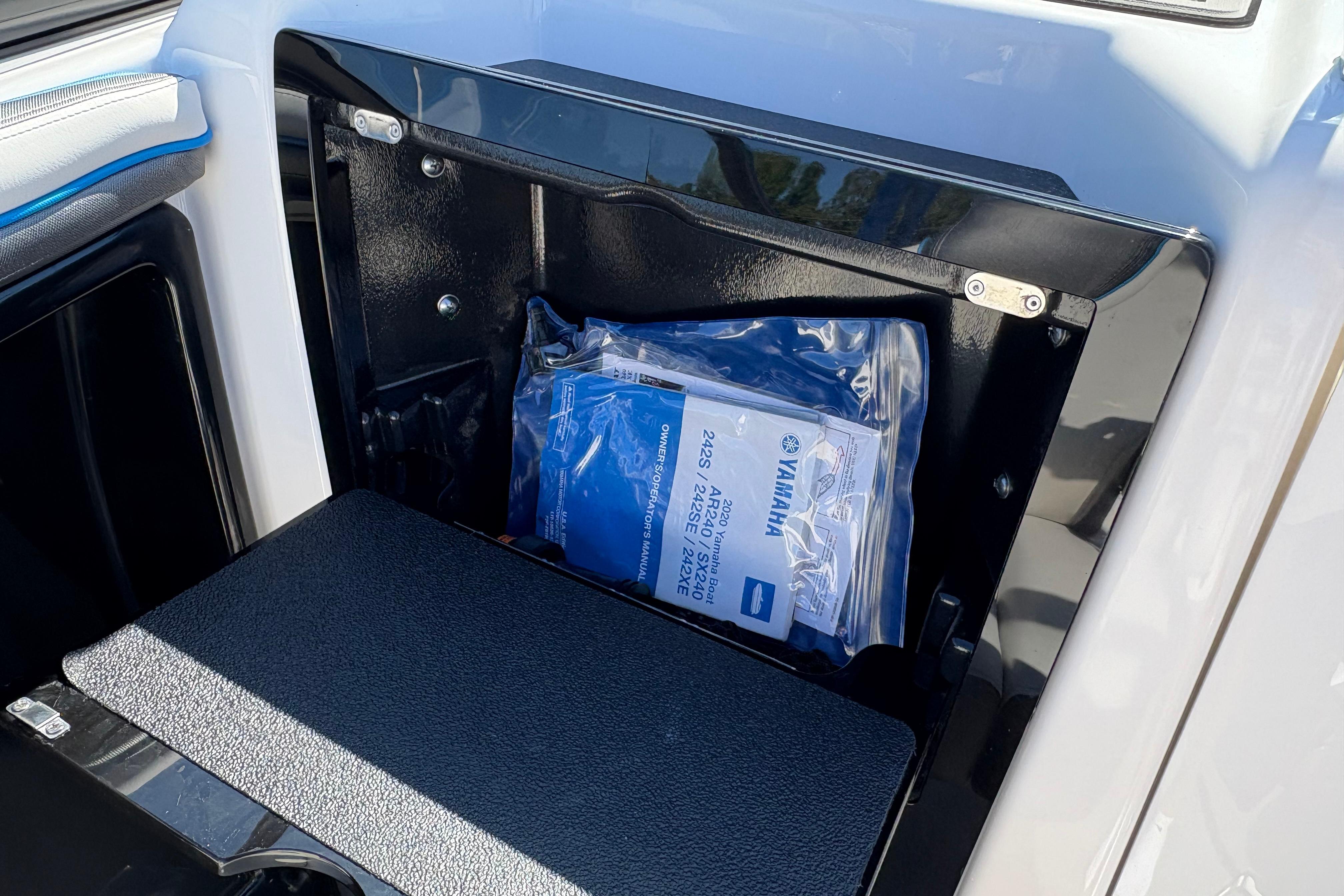2020 Yamaha AR240 boat storage compartment with manual inside.