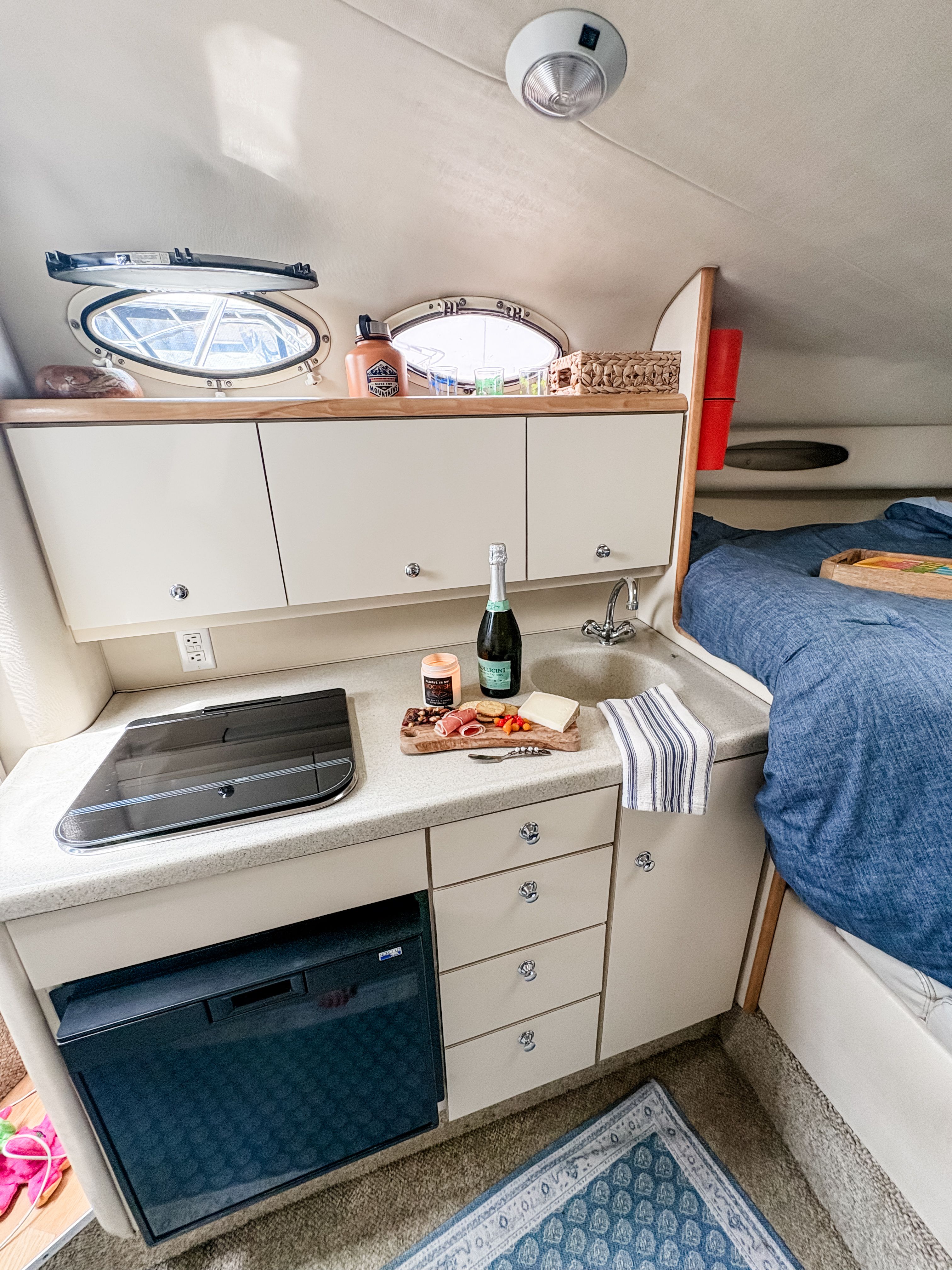 Interior of a 1997 Wellcraft Martinique yacht kitchen with bed.