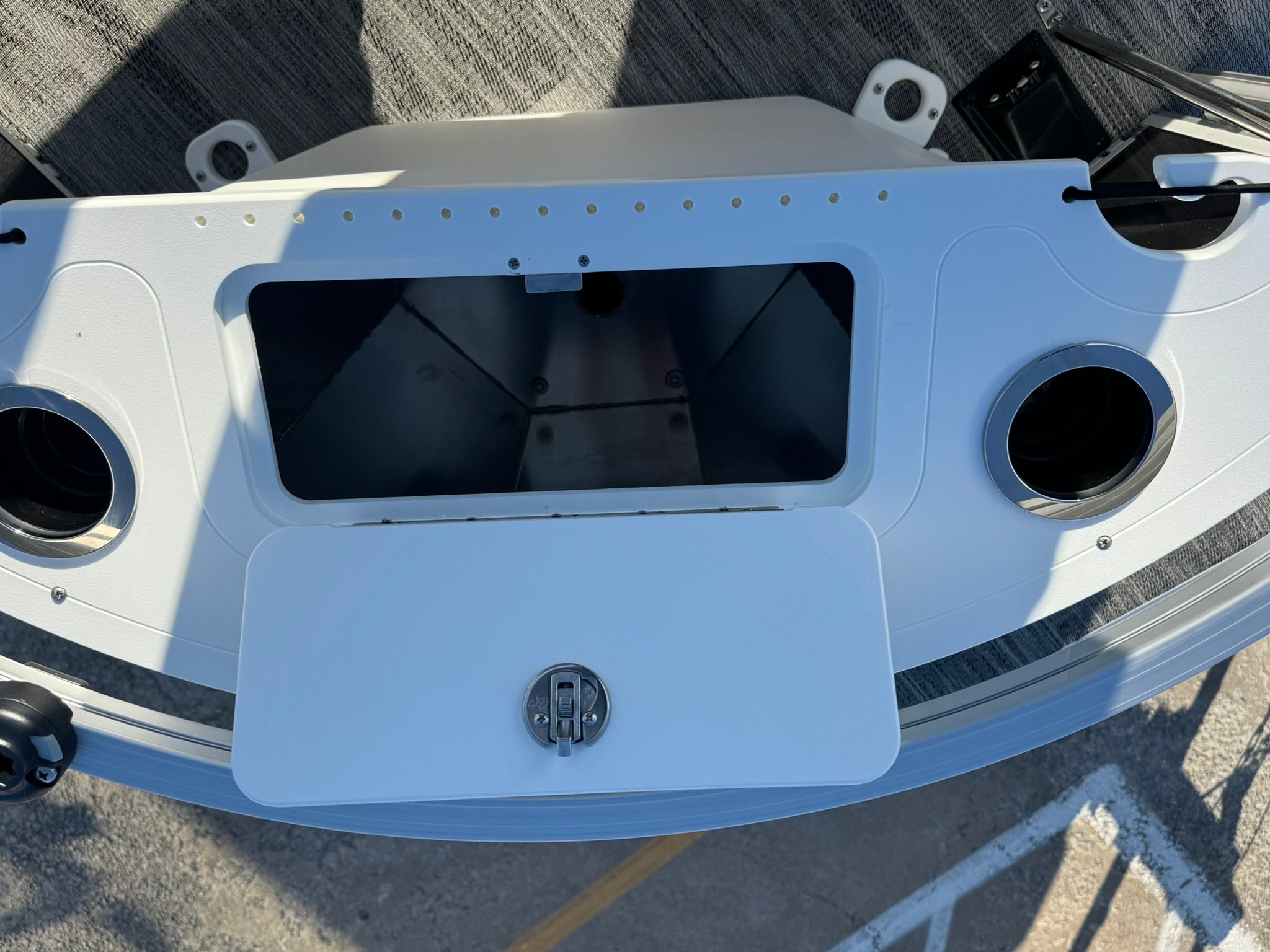 Landau 23C Atlantis 2026 boat console with storage and cup holders.