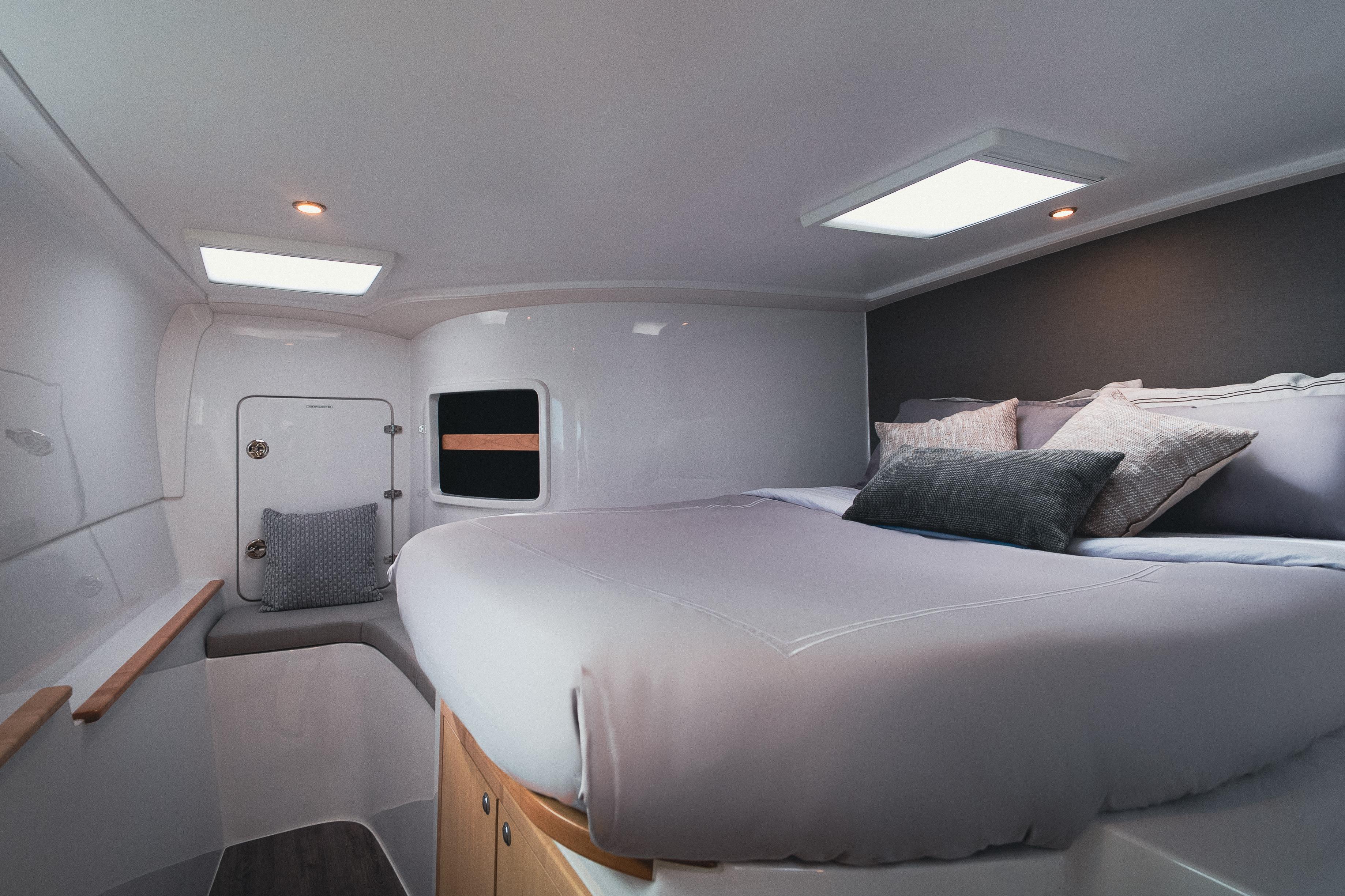 Luxurious cabin interior of 2026 Seawind 1160XL catamaran with cozy bedding and modern design.