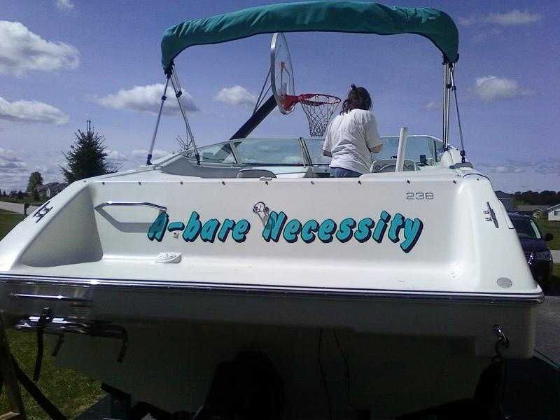 The image shows a 1993 Chris-Craft 238 Cuddy Concept boat with a basketball hoop in the background.