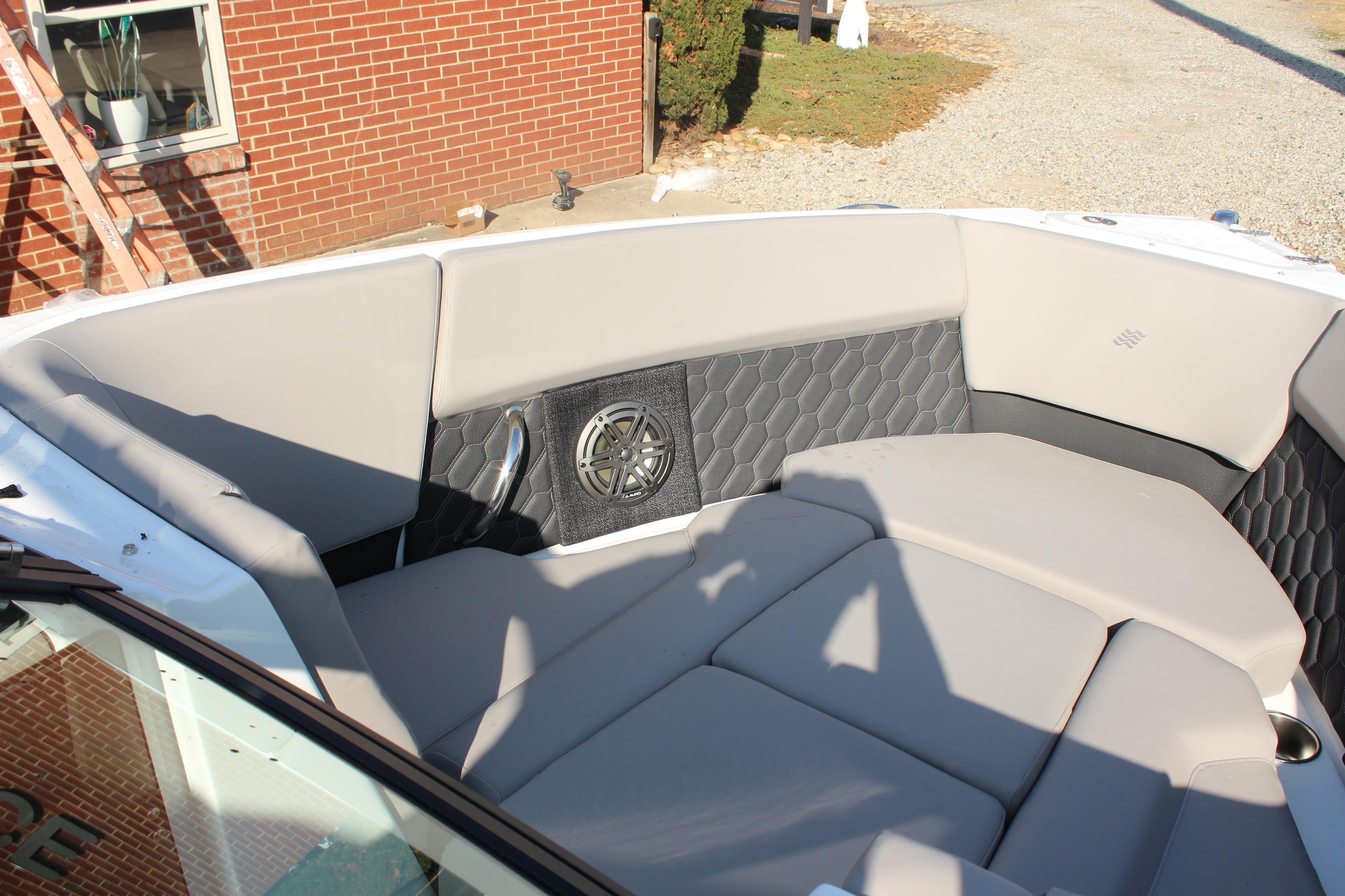 2026 Four Winns H4 boat interior with cushioned seating and speaker system.