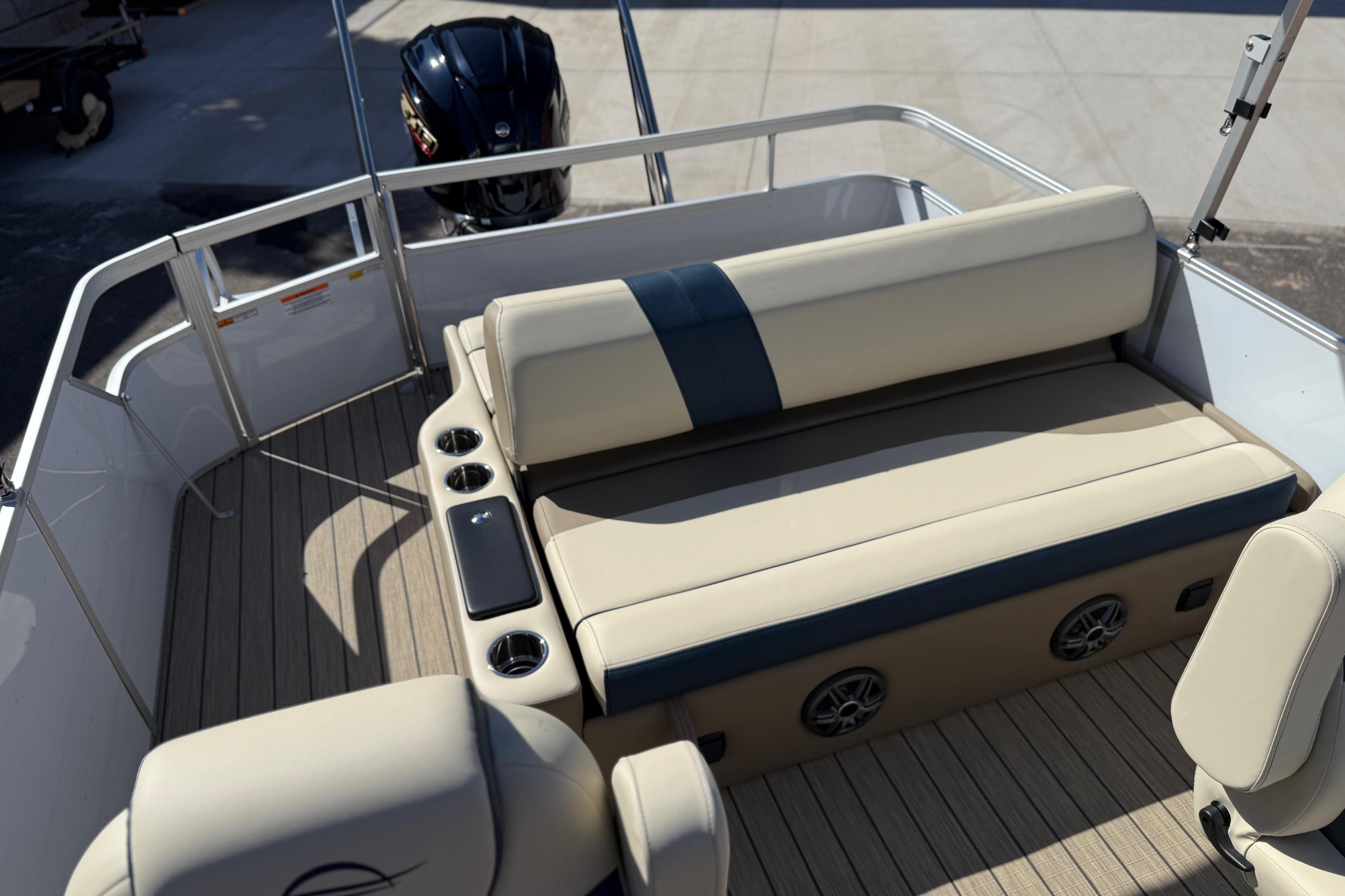 2026 SunCatcher Select 322SL boat interior with beige seating and cup holders.