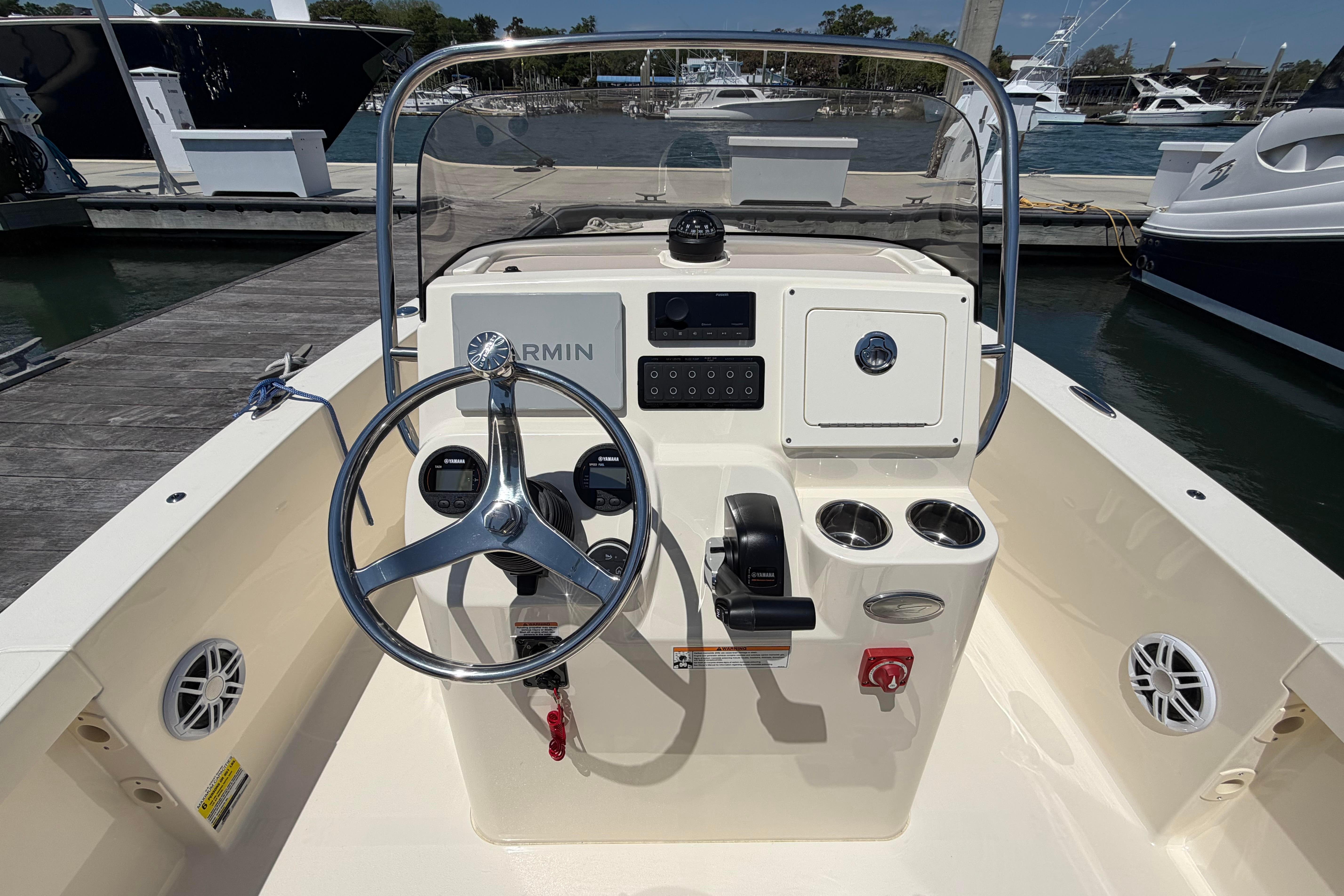 2026 Scout 188 Sportfish boat dashboard with steering wheel and controls at marina.