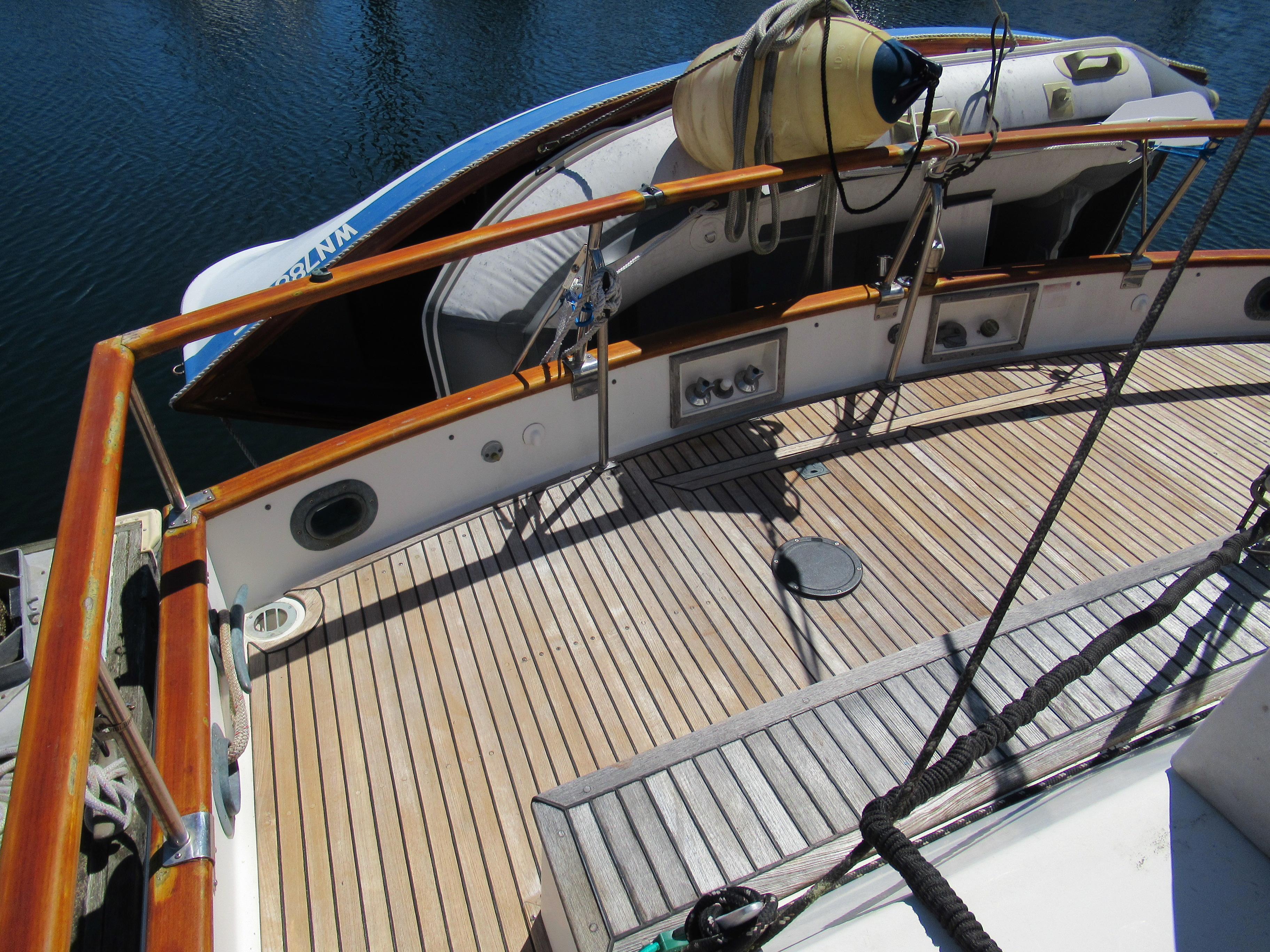 1990 Grand Banks Classic yacht deck with wooden finish and lifeboat.