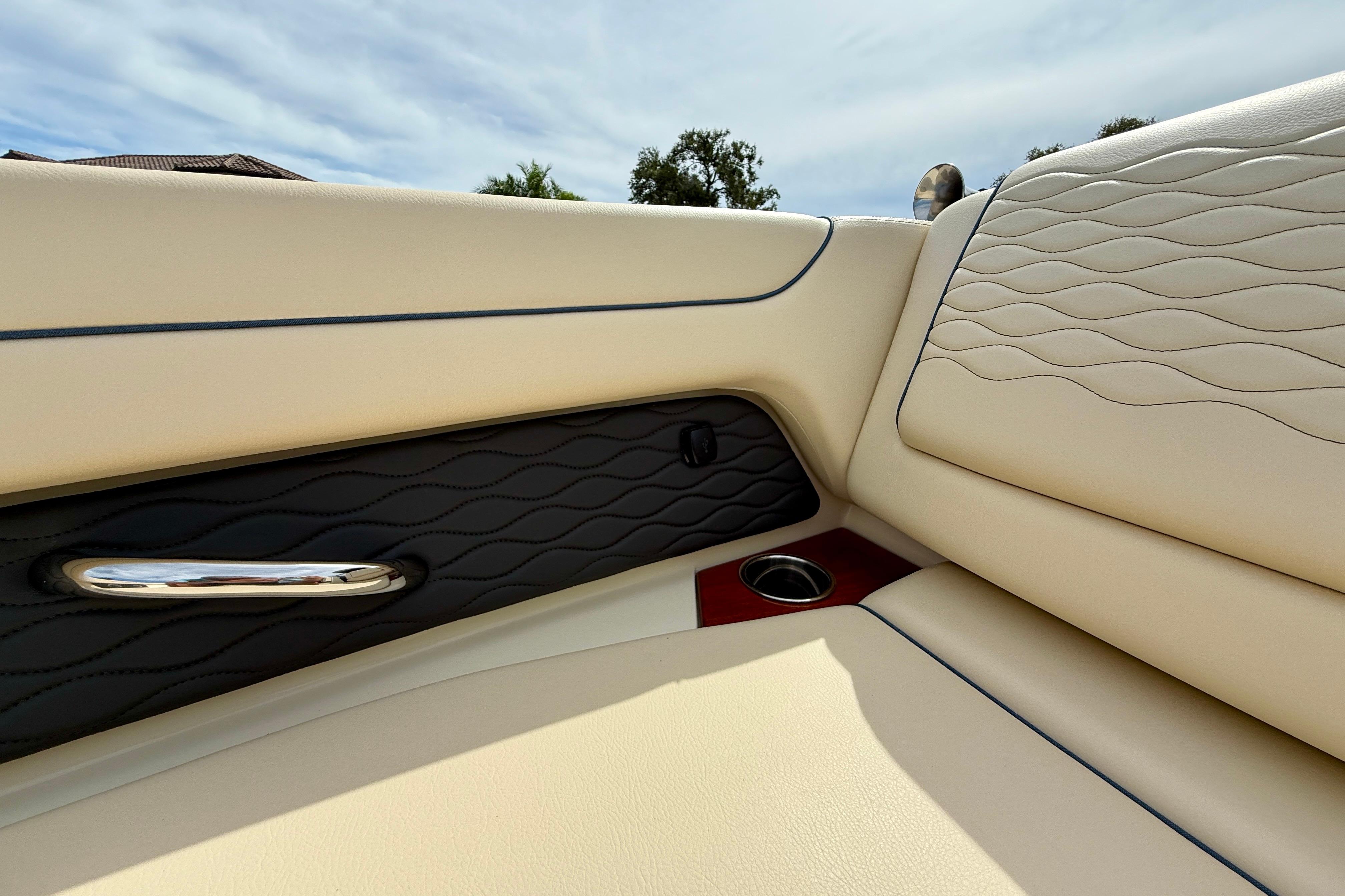 2026 Chris-Craft Sportster 28 interior with elegant beige and black leather upholstery.