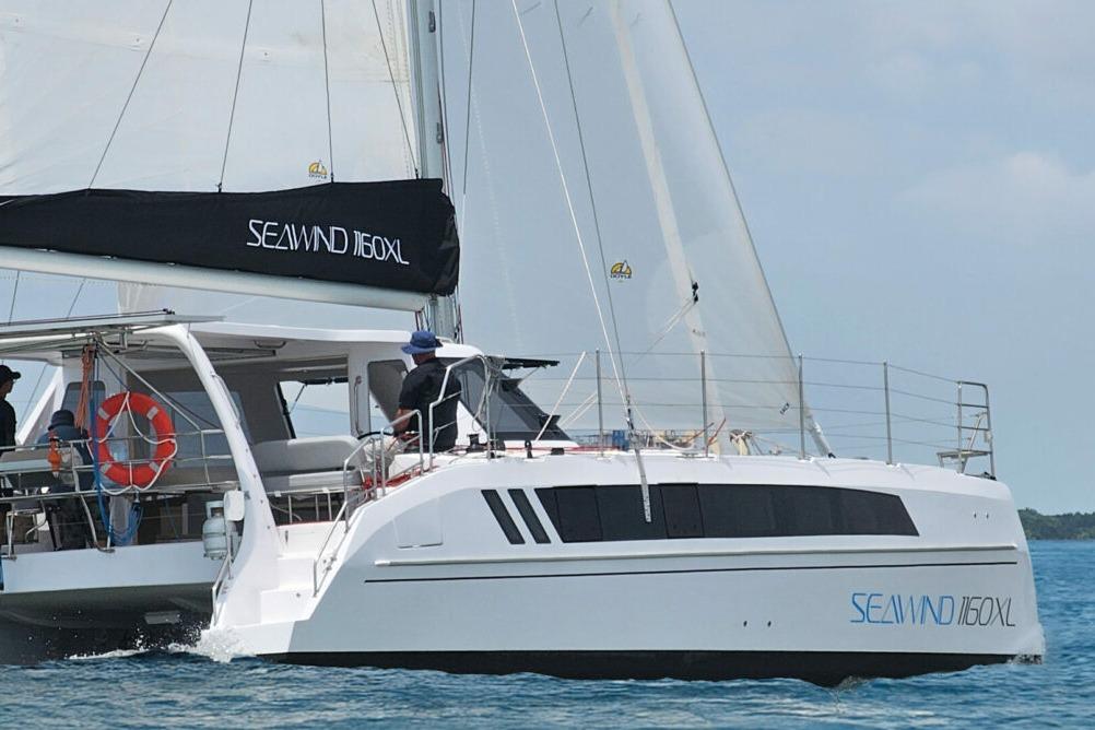 2026 Seawind 1160 XL catamaran sailing on open water, featuring sleek design and spacious deck.