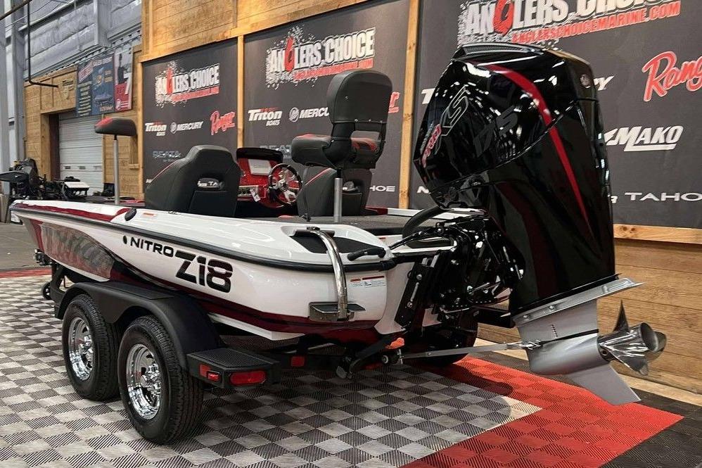 2026 Nitro Z18 Pro boat displayed indoors with powerful outboard motor.