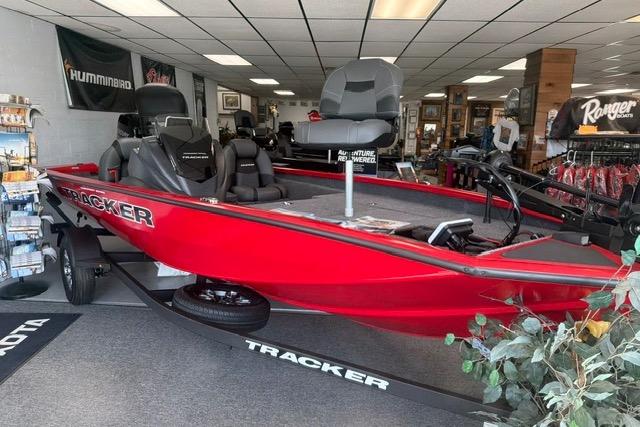 2026 Tracker Pro Team 175 boat in showroom, vibrant red color, displayed on trailer.