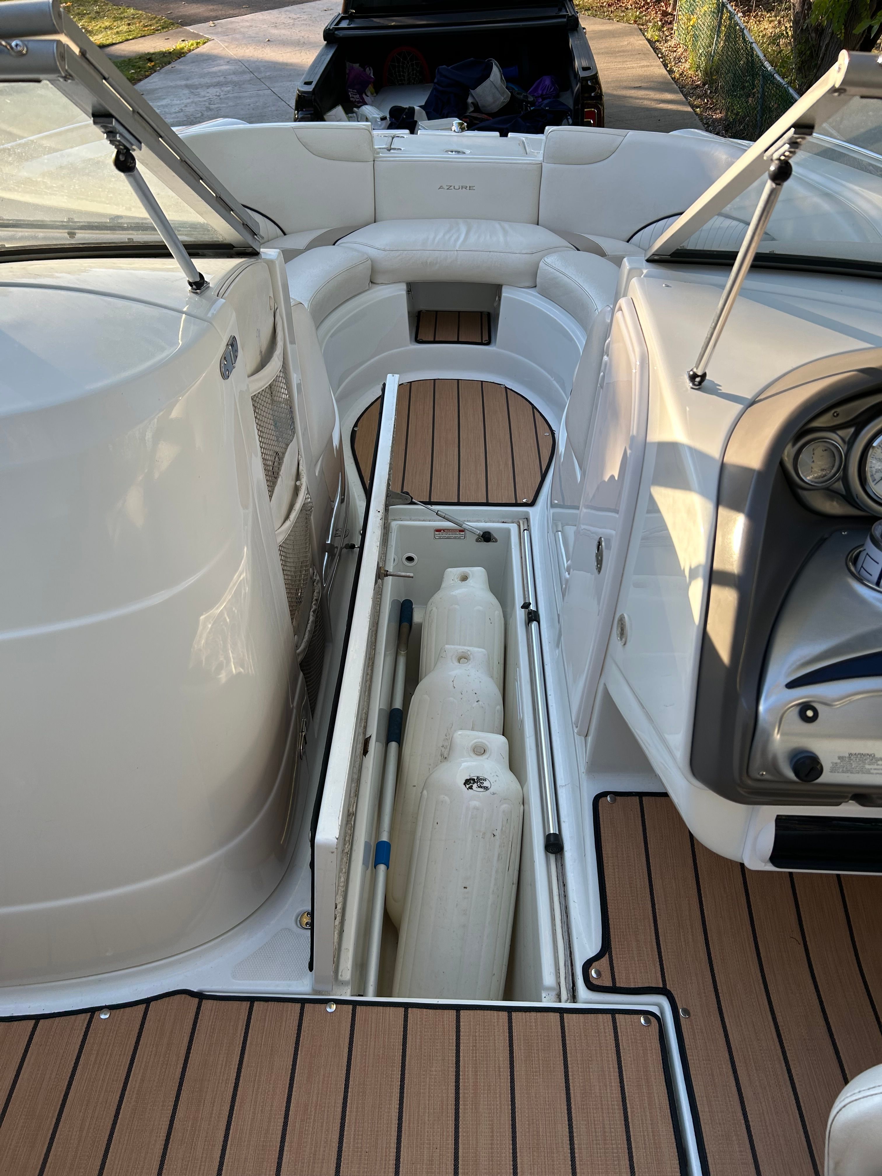 The image shows the cockpit of a 2008 Azure AZ220 boat with open storage space.