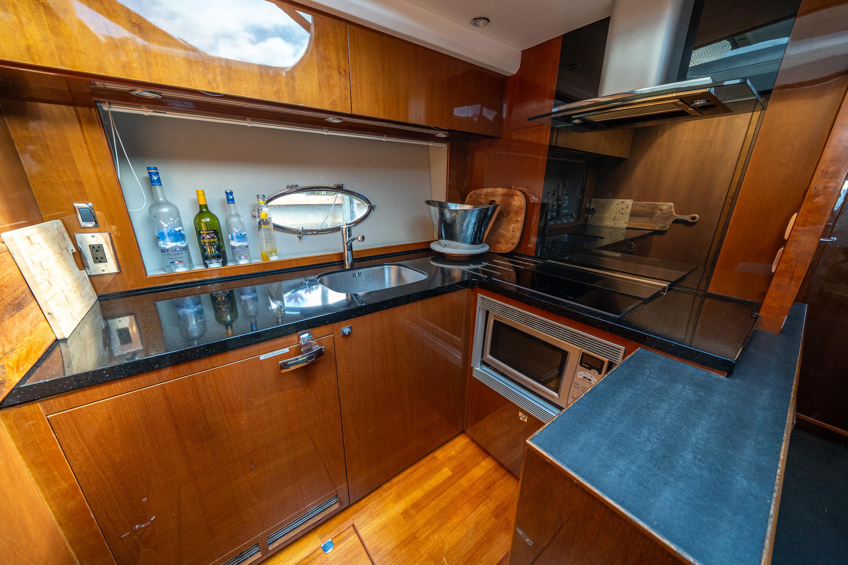 Luxurious kitchen interior of 2012 Princess V52 yacht with modern appliances and sleek design.