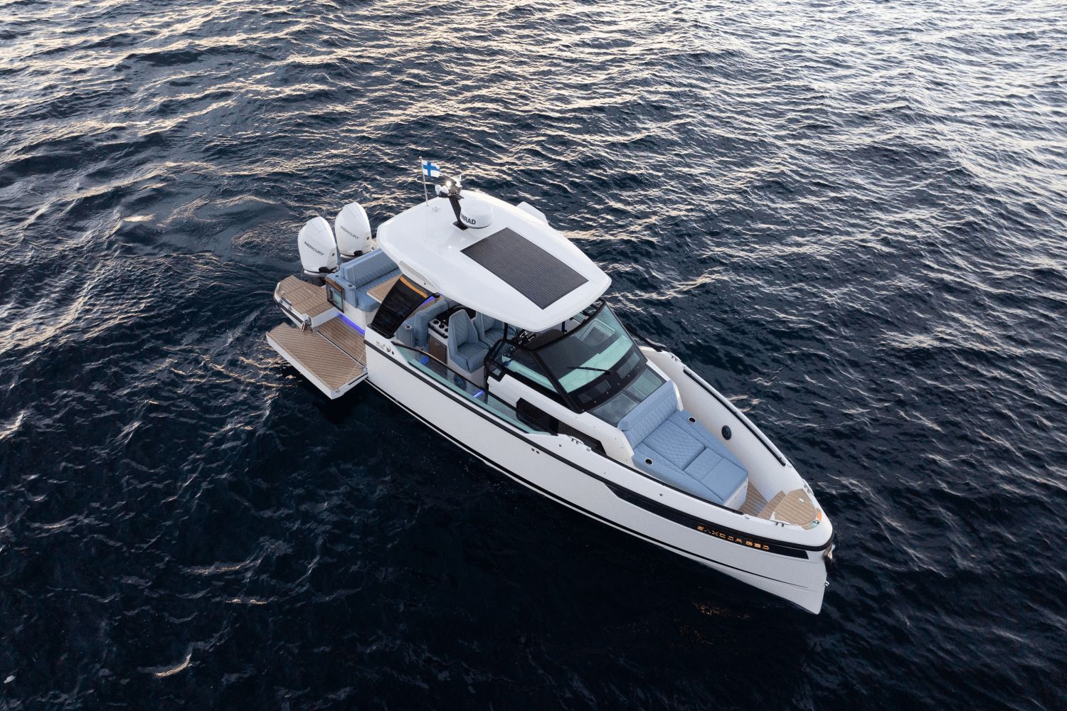 A modern motorboat cruising on calm waters. It features a sleek design and spacious cabin.