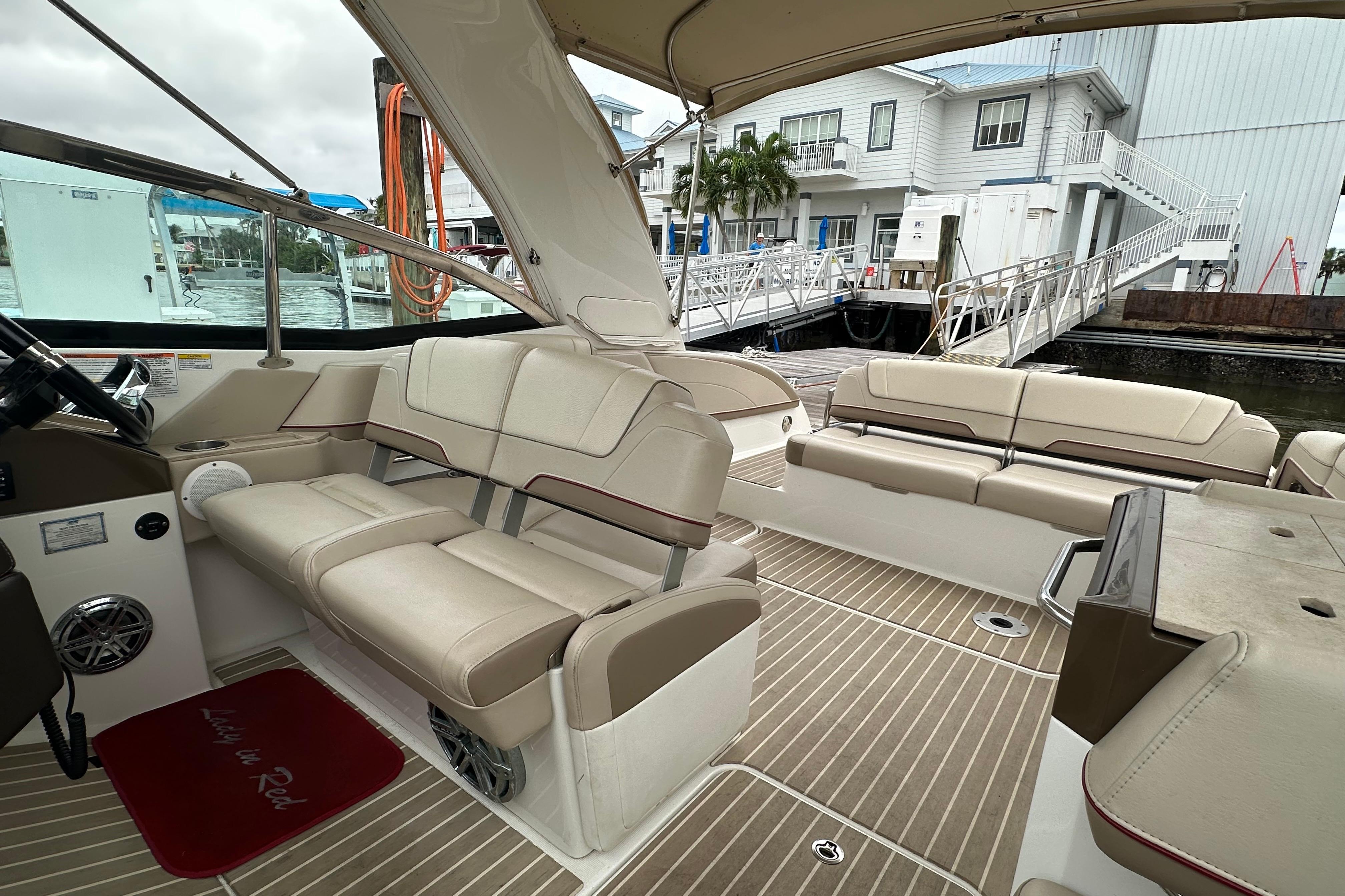 2016 Formula 330 Crossover Bowrider interior with beige seating and wood-style flooring.