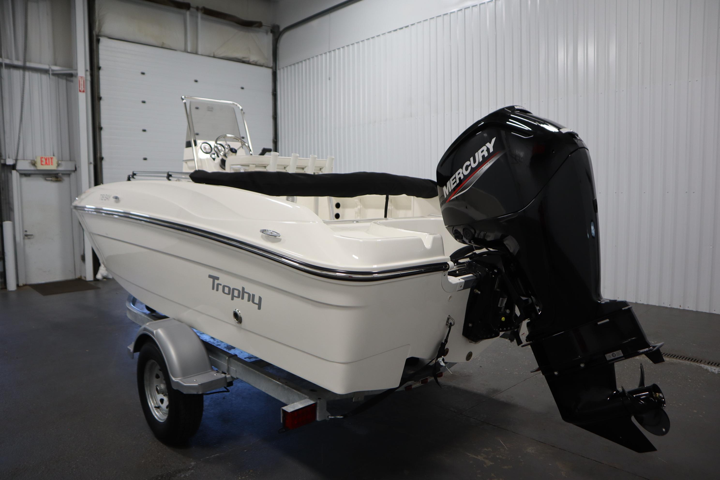 2026 Bayliner Trophy T18 boat with Mercury outboard motor in a garage setting.