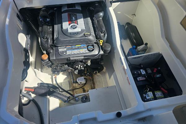 2024 Bayliner DX 2250 engine compartment with visible motor and battery setup.