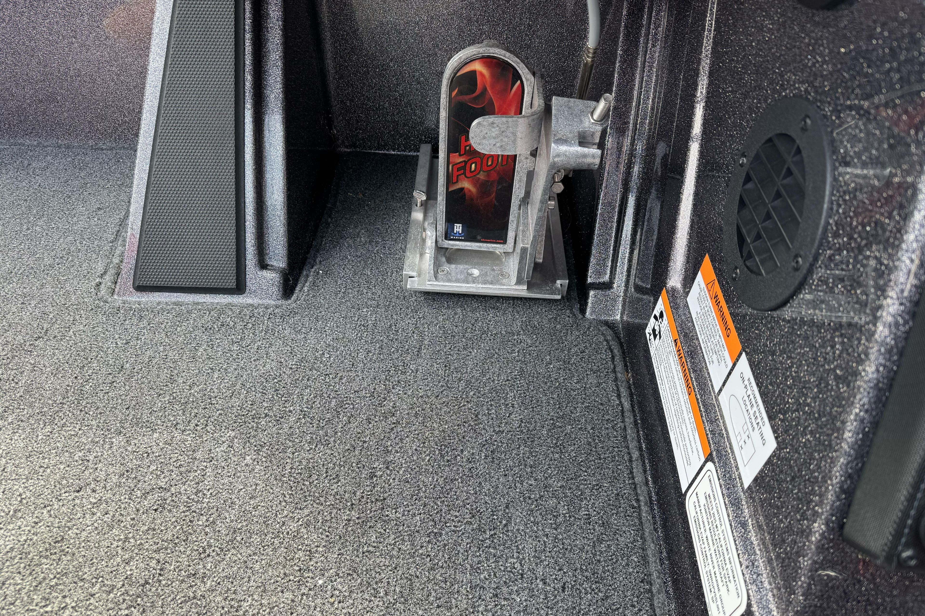 2025 Ranger Z521 boat interior with foot pedal and warning labels.