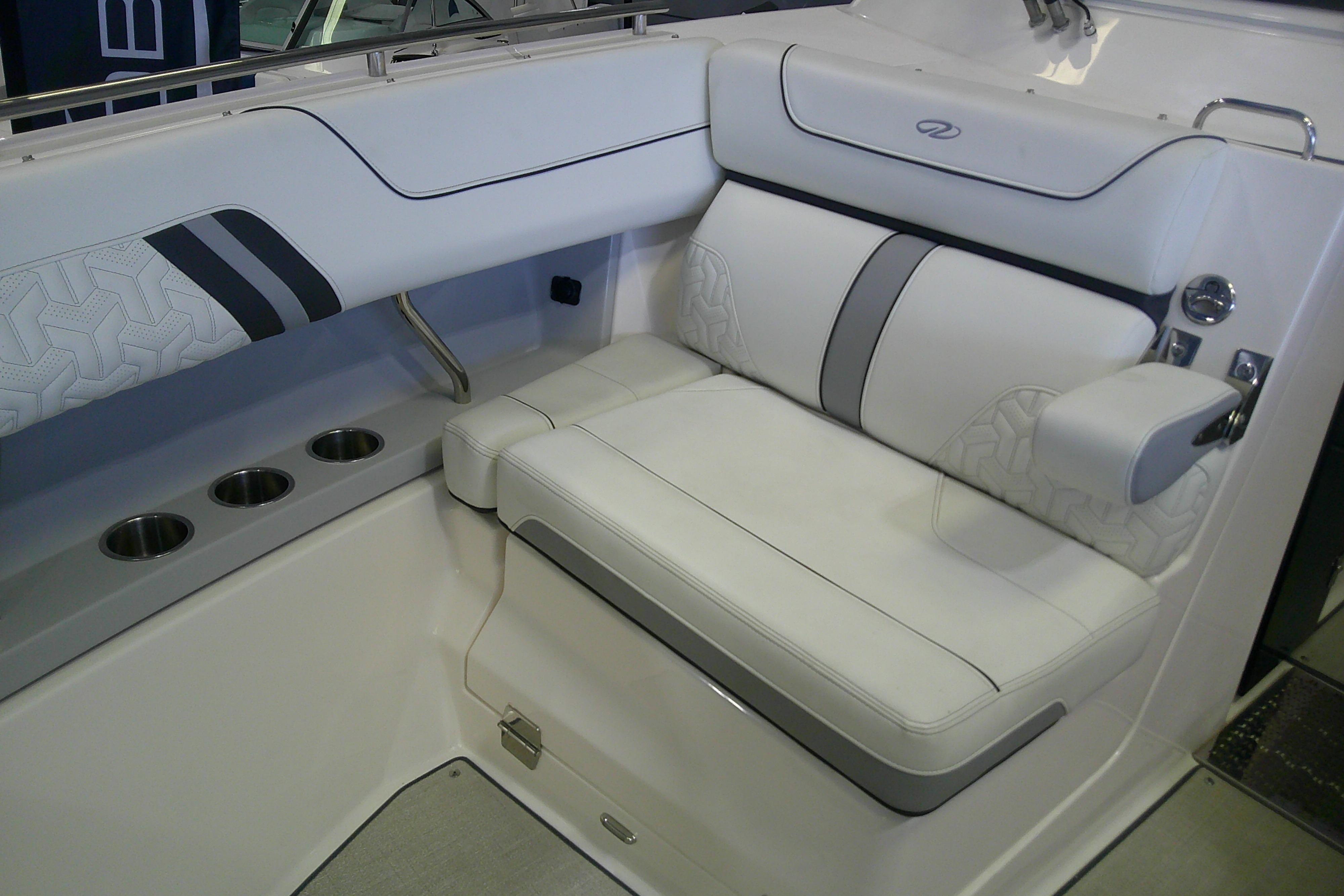 Luxurious seating in 2023 Regal LX36 boat with cup holders and stylish upholstery.