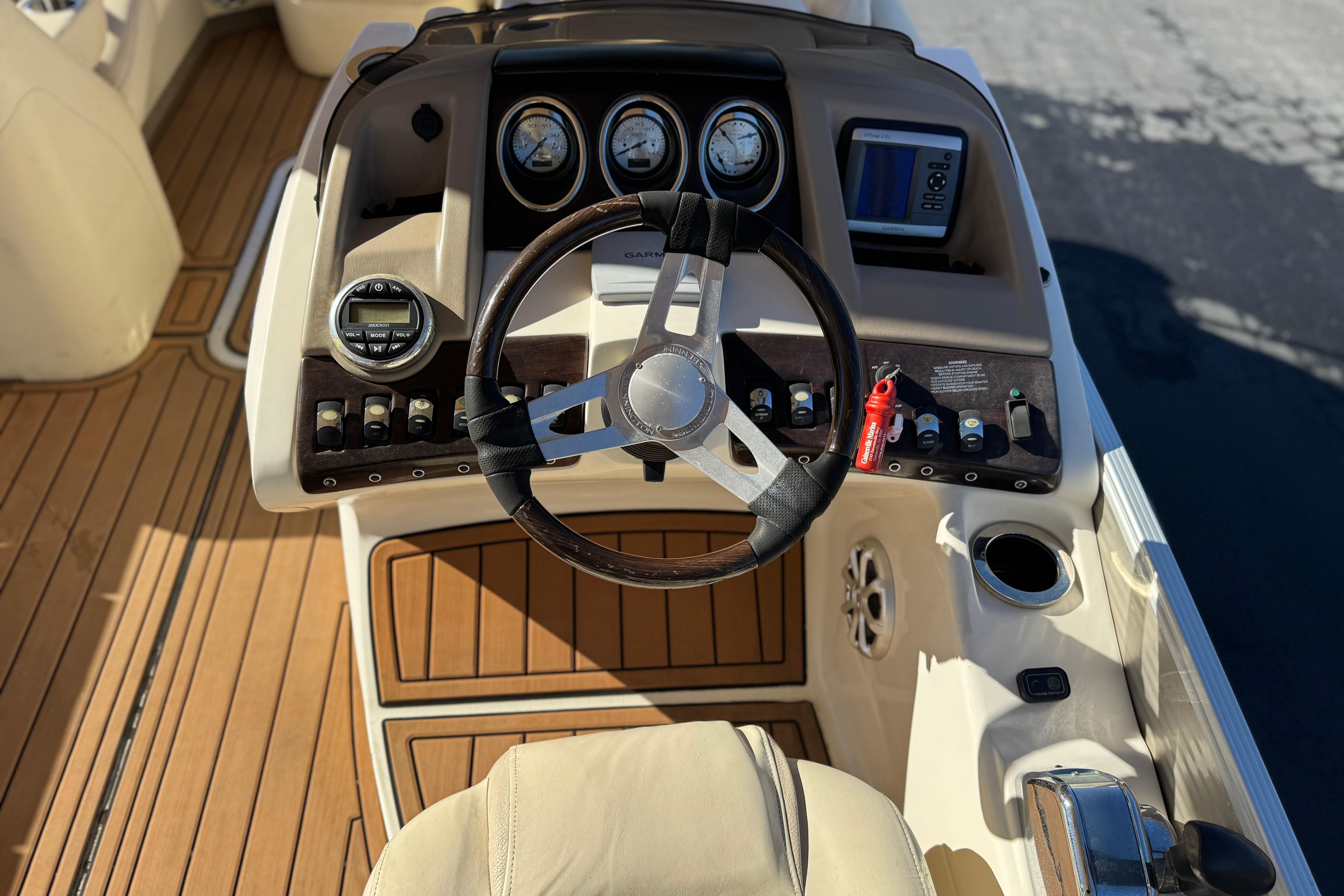 2013 Bennington 2575QCW I/O boat dashboard with steering wheel and controls.