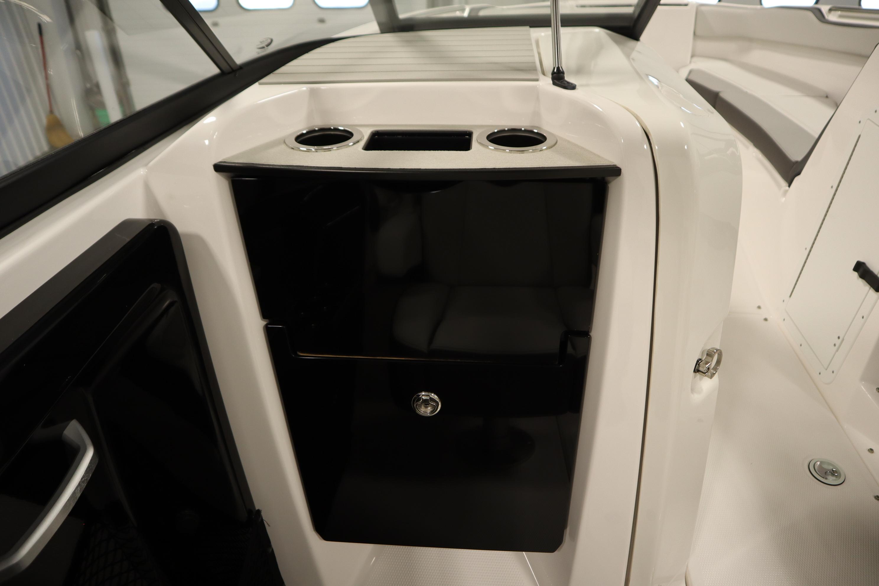 2026 Yamaha Boats AR250 interior with sleek black storage compartment and cup holders.
