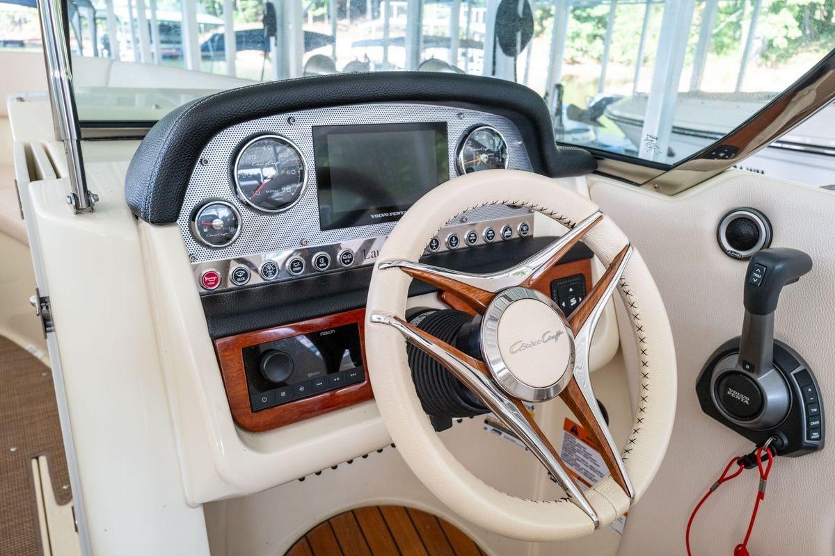 2023 Chris-Craft Launch 27 dashboard with steering wheel and control panel.