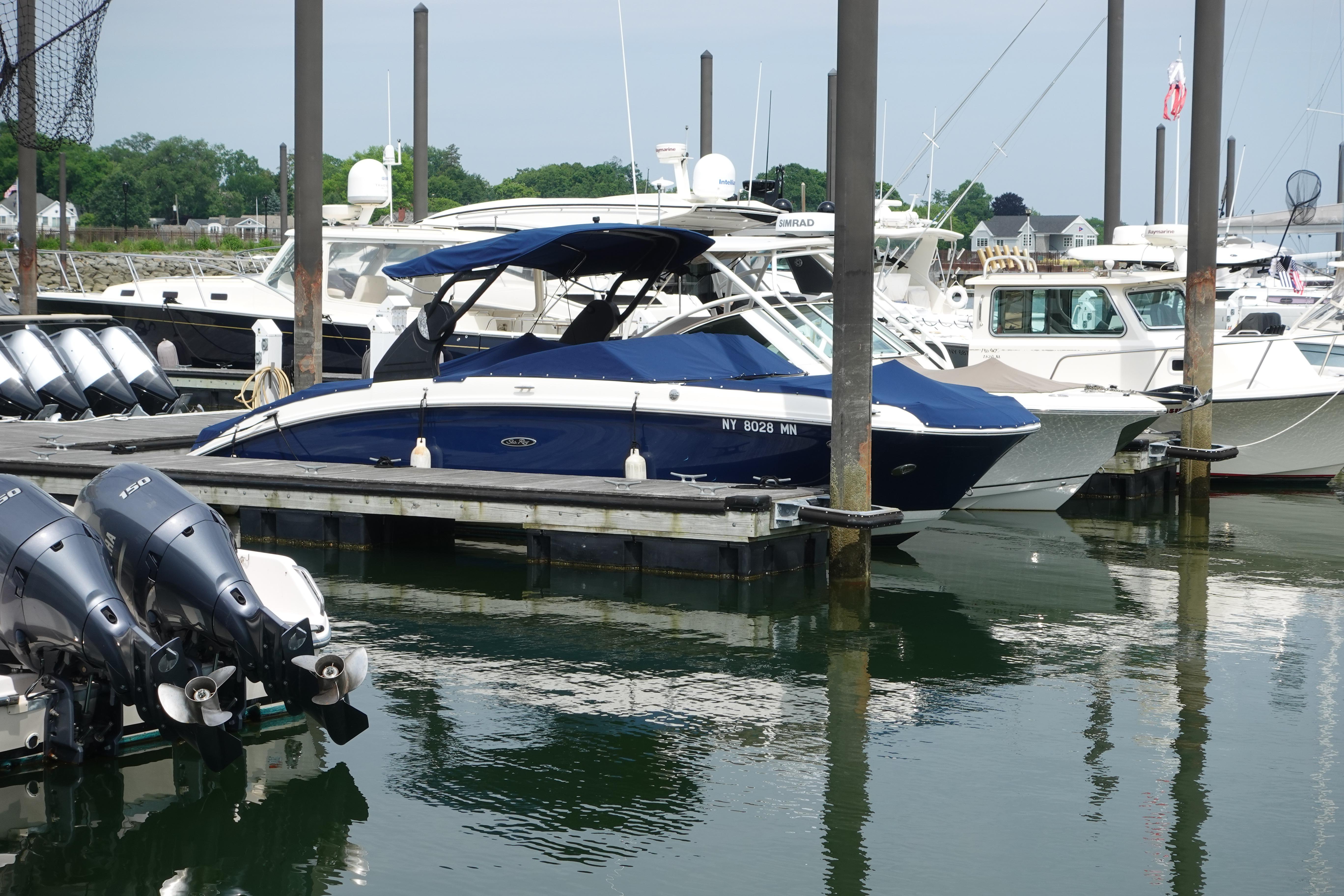 2018 Sea Ray SDX 270 boat docked at marina with other vessels.