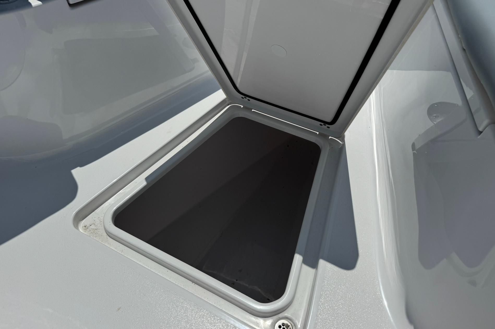 Open storage compartment on 2026 Sportsman Open 262 Center Console boat.