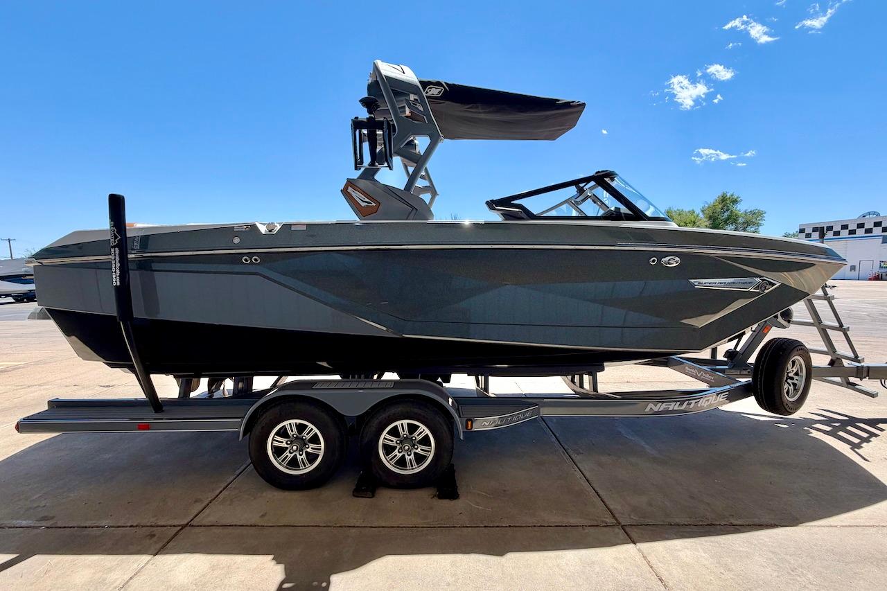 2021 Nautique Super Air Nautique G23 boat on trailer under clear blue sky.