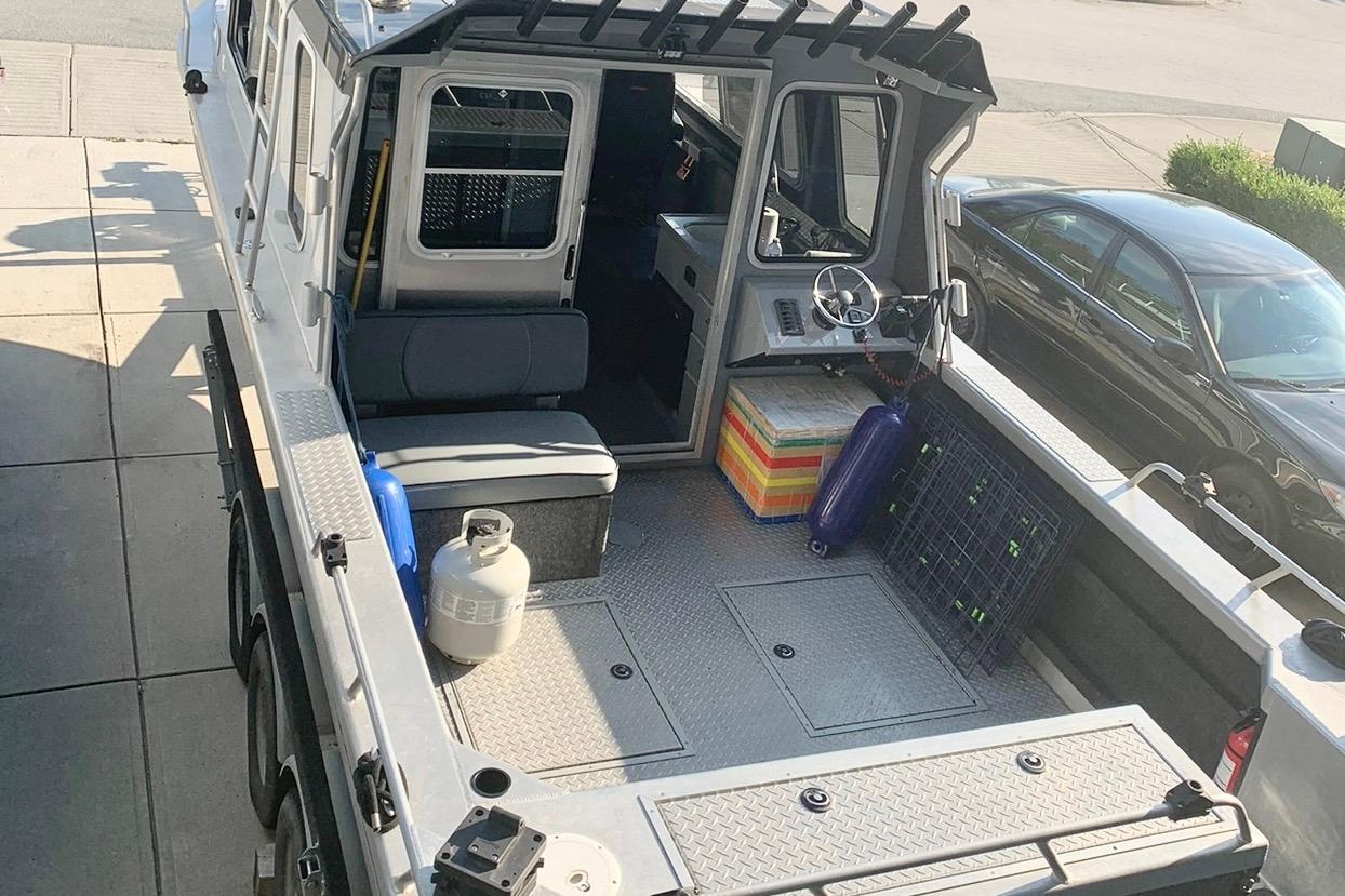 2017 Thunder Jet 28 Pilot boat interior with seating, steering wheel, and storage compartments.