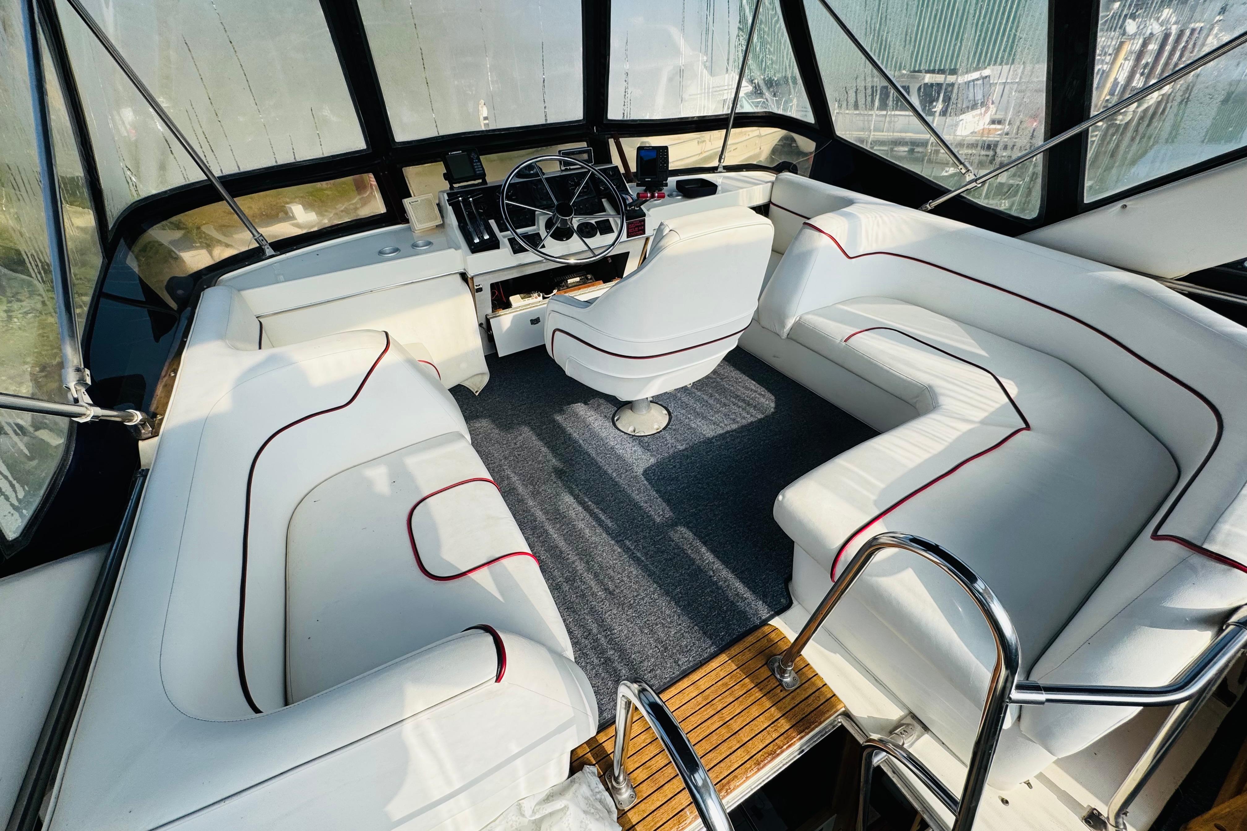 1990 Bayliner 3888 Motoryacht interior with white seating and helm station.