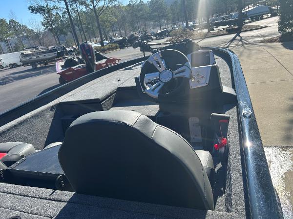 2025 Tracker Savage 215 boat interior with steering wheel and seating in sunlight.