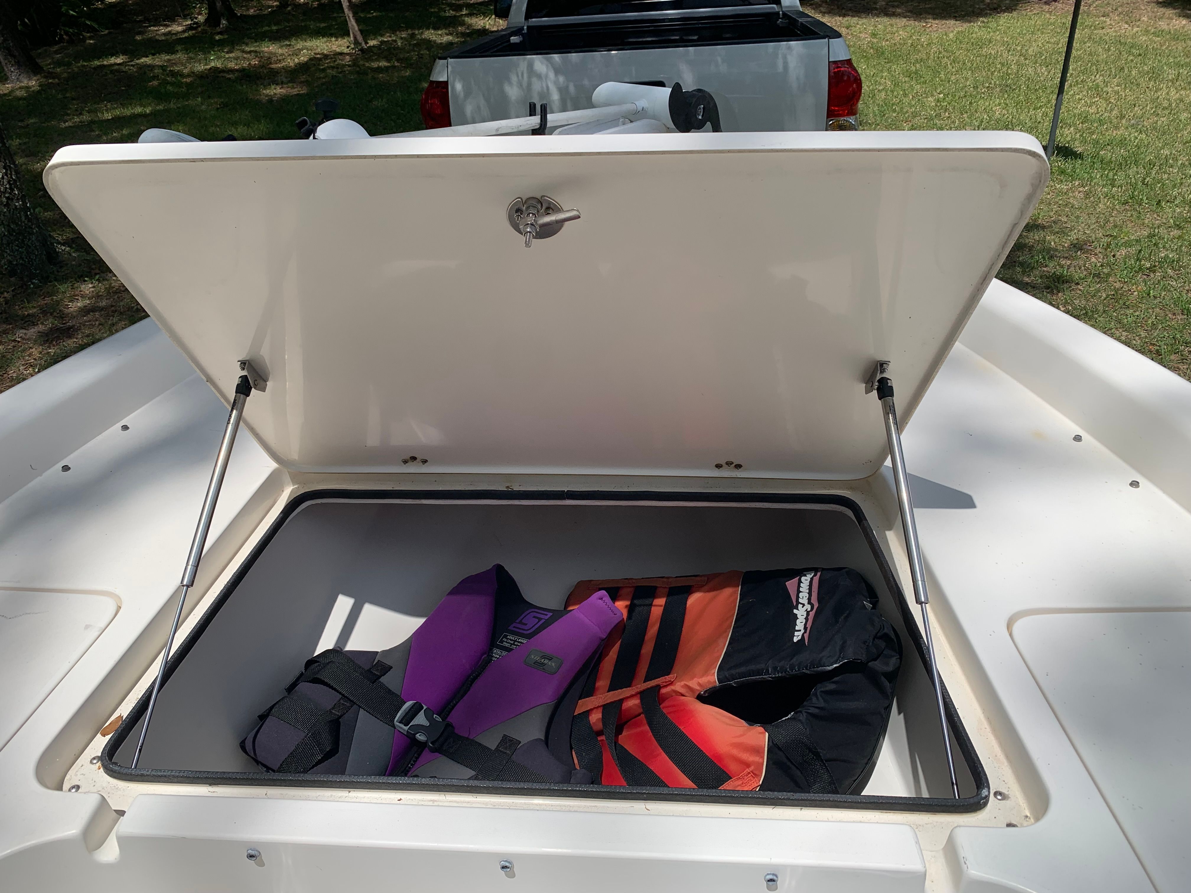 Open storage compartment of 2007 ShearWater 23 LTZ with life jackets.