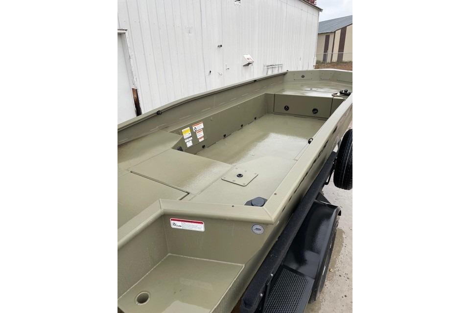2026 Tracker Grizzly 1650 T Prairie Wings Edition boat, olive green, docked outdoors.