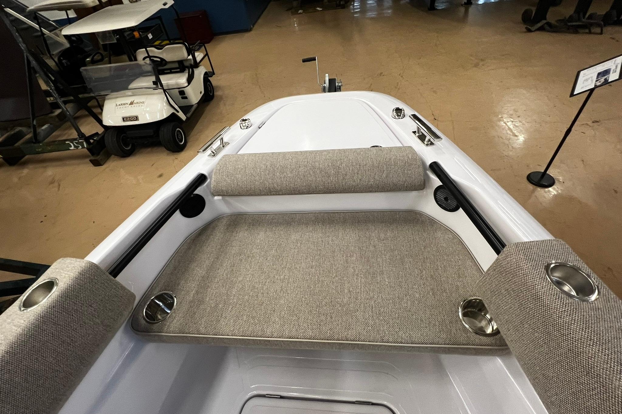 2025 Axopar 22 Spyder boat interior with cushioned seating and cup holders.
