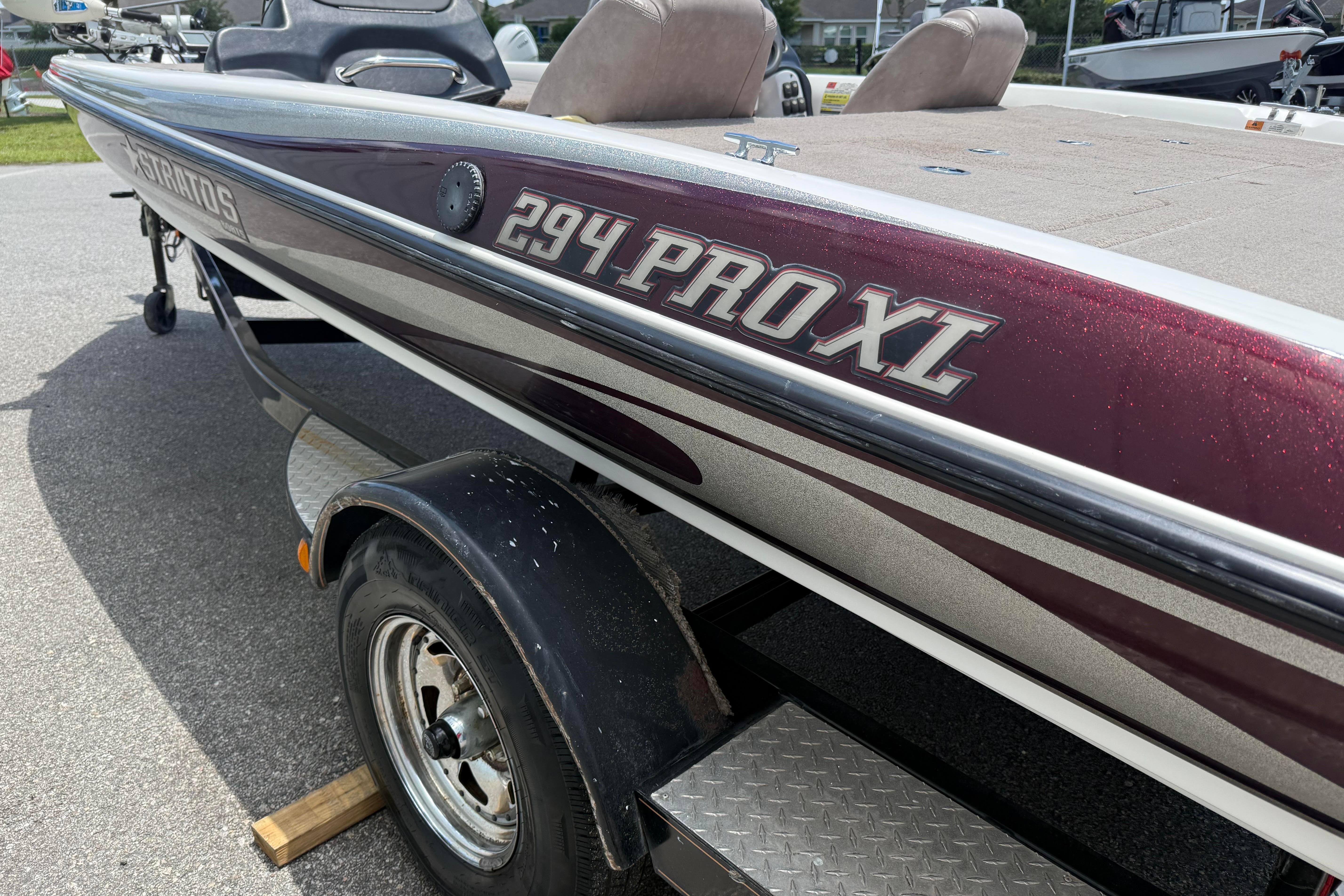 2006 Stratos 294 Pro XL boat on trailer, maroon and silver detailing.