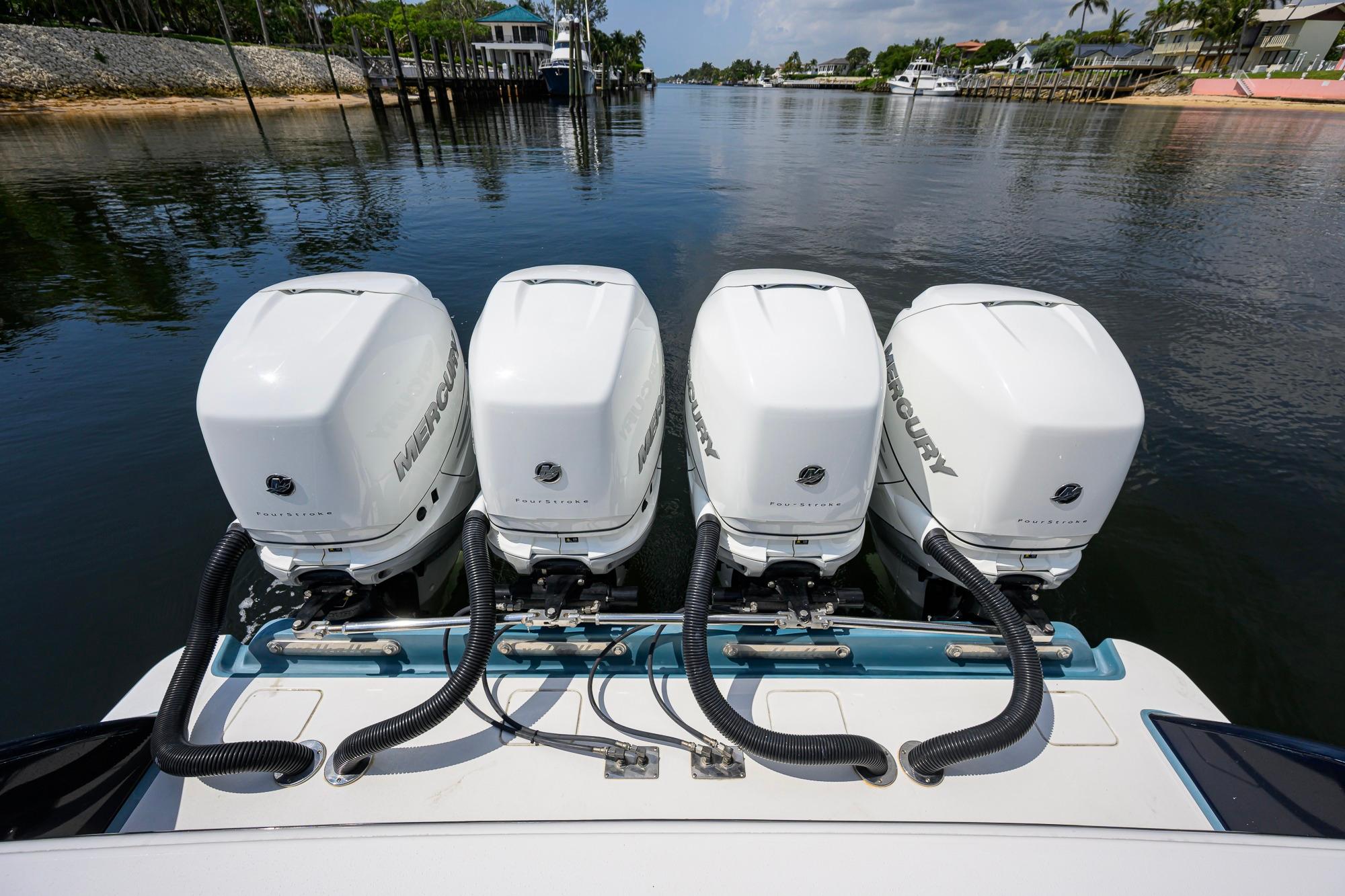 Four Mercury outboard engines on a 2020 Valhalla Boatworks V-41, docked by a calm waterfront.