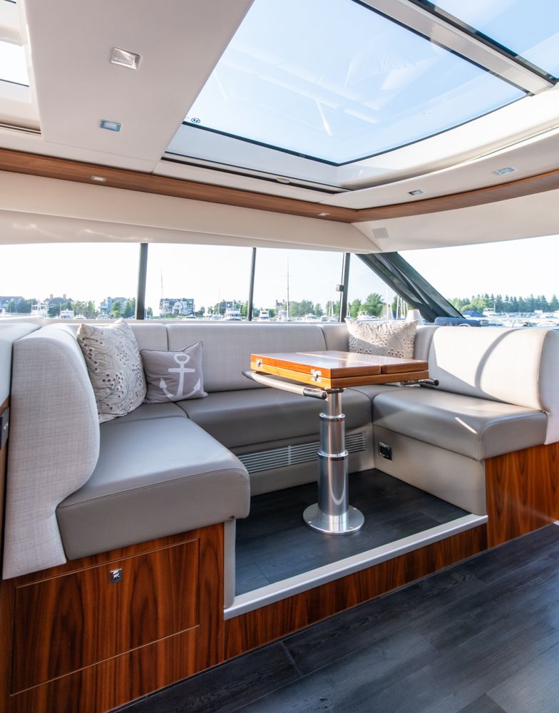 Luxurious interior of 2022 Riviera 6000 Sport Yacht Platinum with skylight and elegant seating.