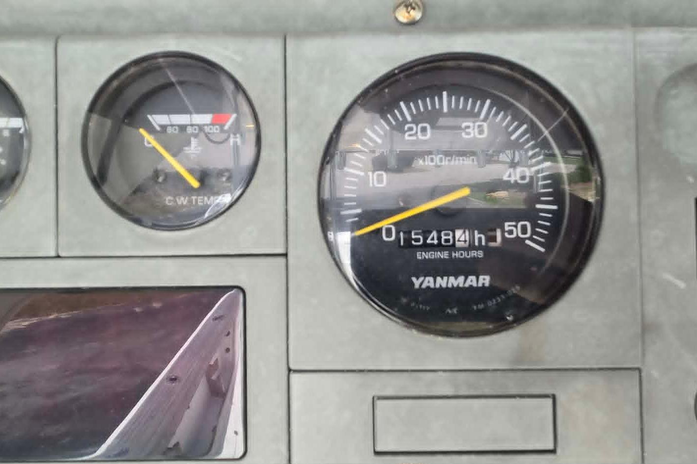Instrument panel of a 2003 True World Marine 286 boat, showing engine hours and temperature gauges.