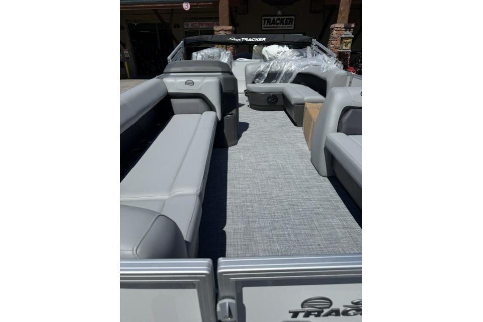 2026 Sun Tracker Party Barge 18 DLX interior with gray seating and spacious layout.