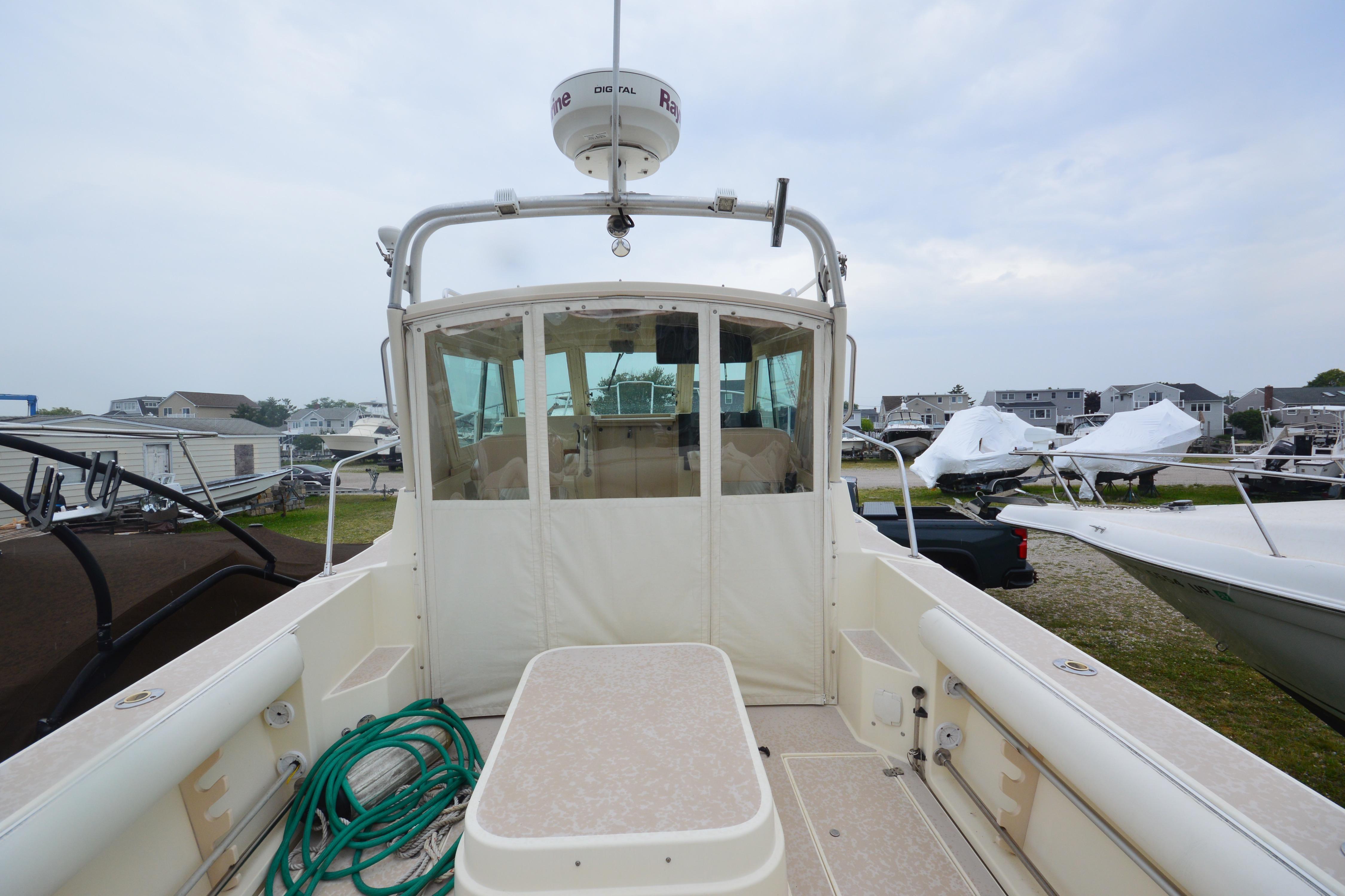 2001 Albin 28 Tournament Express boat with enclosed cabin, docked outdoors.