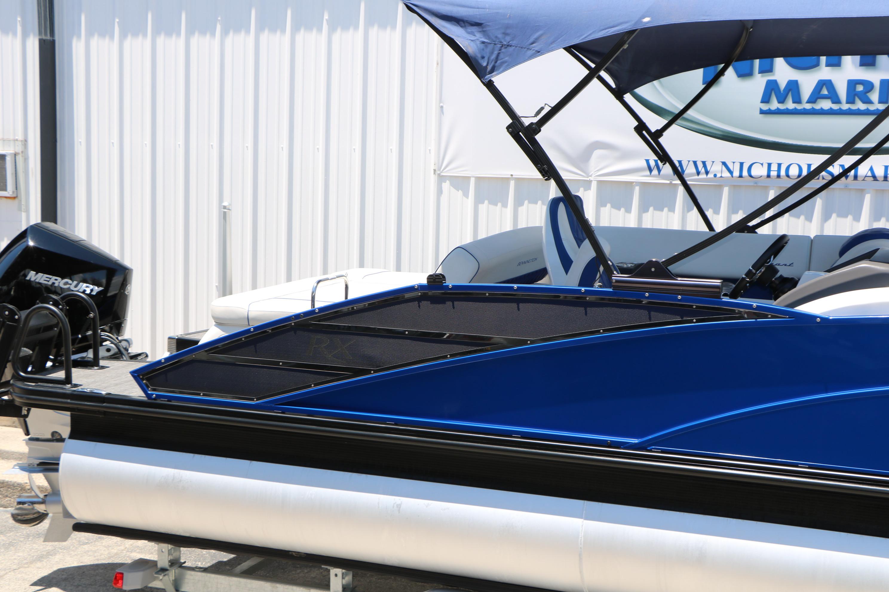 2024 Bennington 23 RX Swingback pontoon boat with blue exterior and Mercury engine.