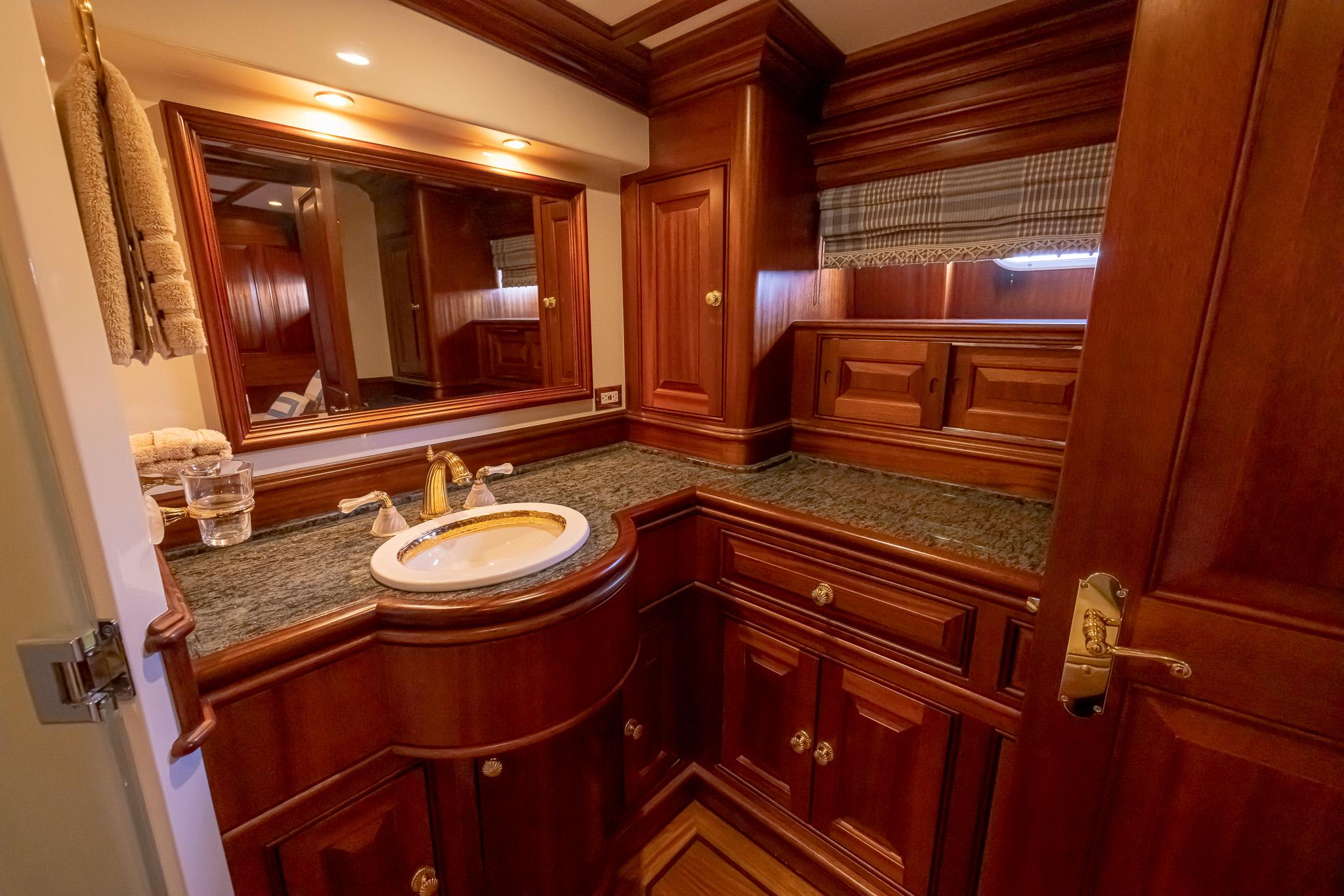 Luxurious wooden bathroom interior on a 2006 Vicem 85 Classic yacht.