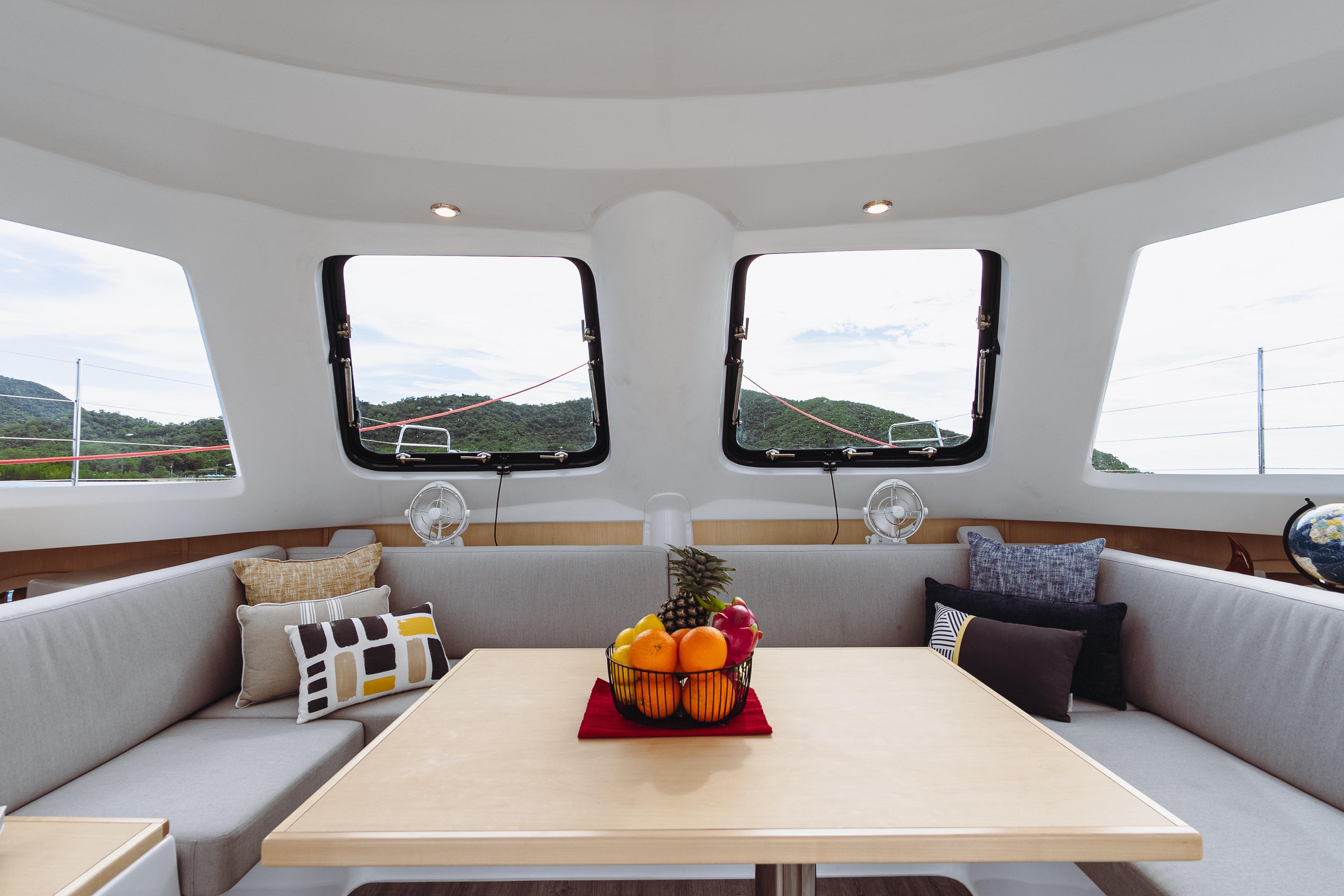 Interior of 2026 Seawind 1160XL catamaran with modern seating and fruit centerpiece.