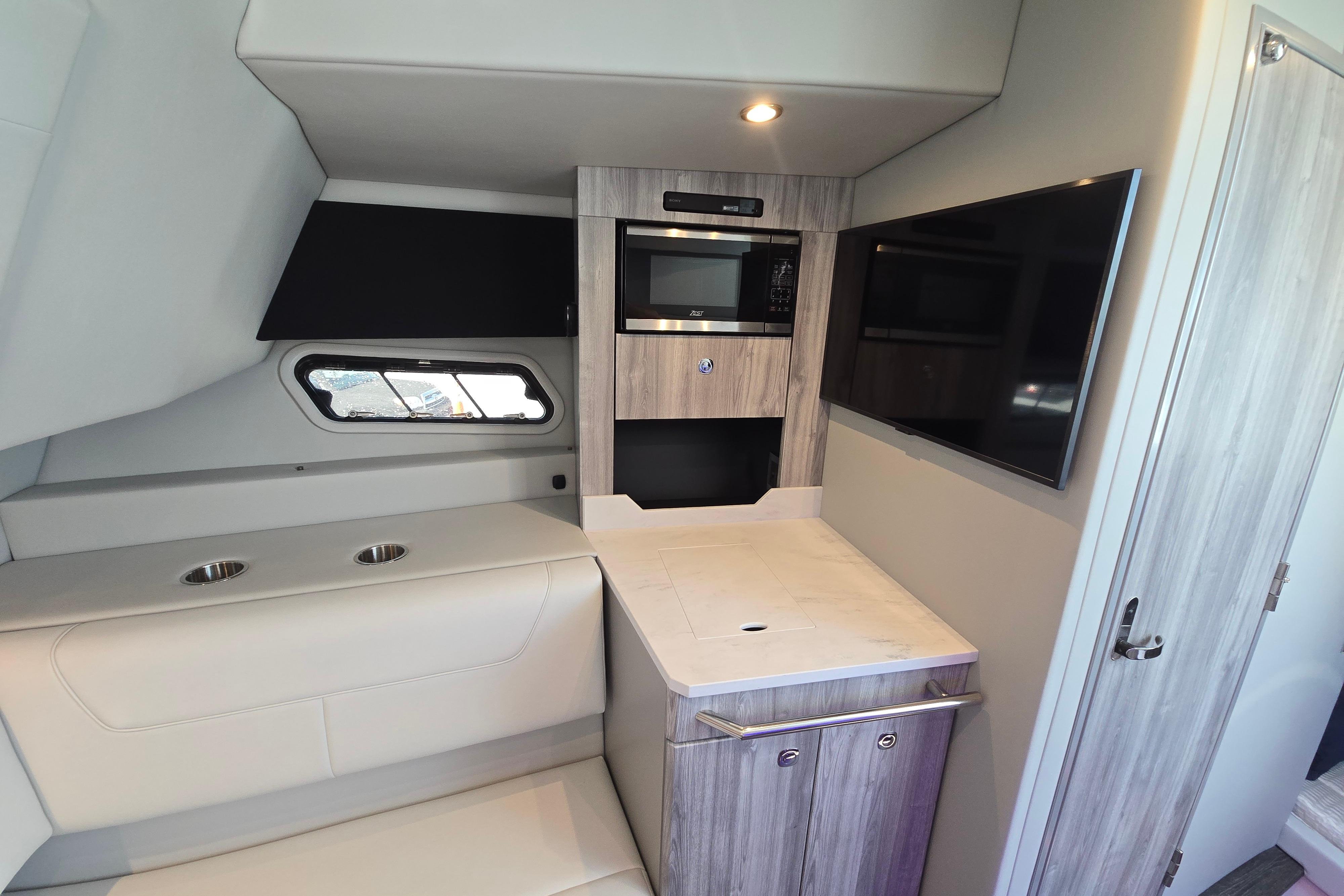 Interior of 2025 Formula 380 Super Sport Crossover OB with modern kitchenette and seating.